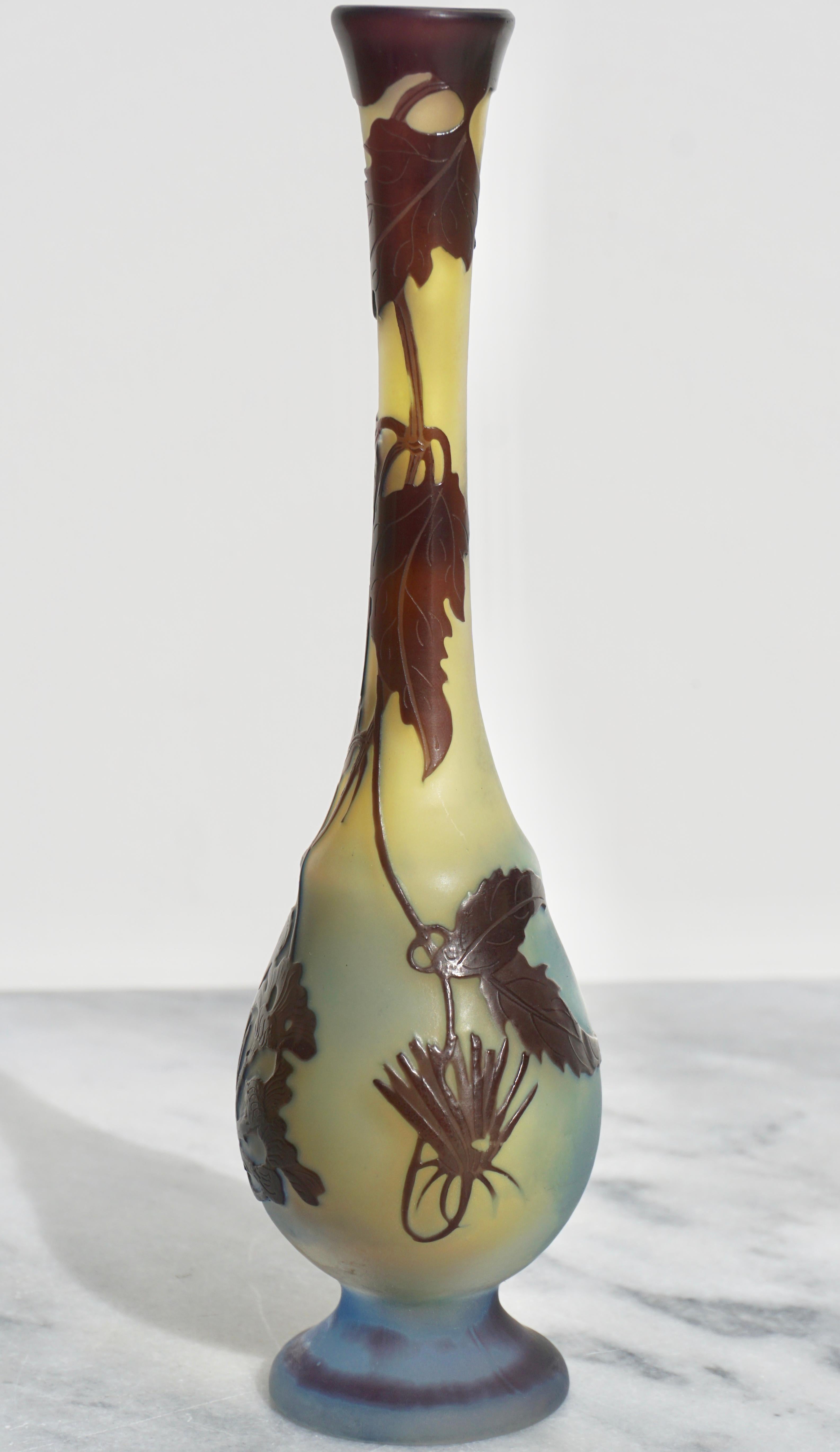 A very pleasing Art Nouveau vase with beautiful form and design. The design is rare and the blue footed base graduating to yellow topside with cameo leaves, vines and flowers make this vase stand out. A respectable 8.75 inches tall with its Art