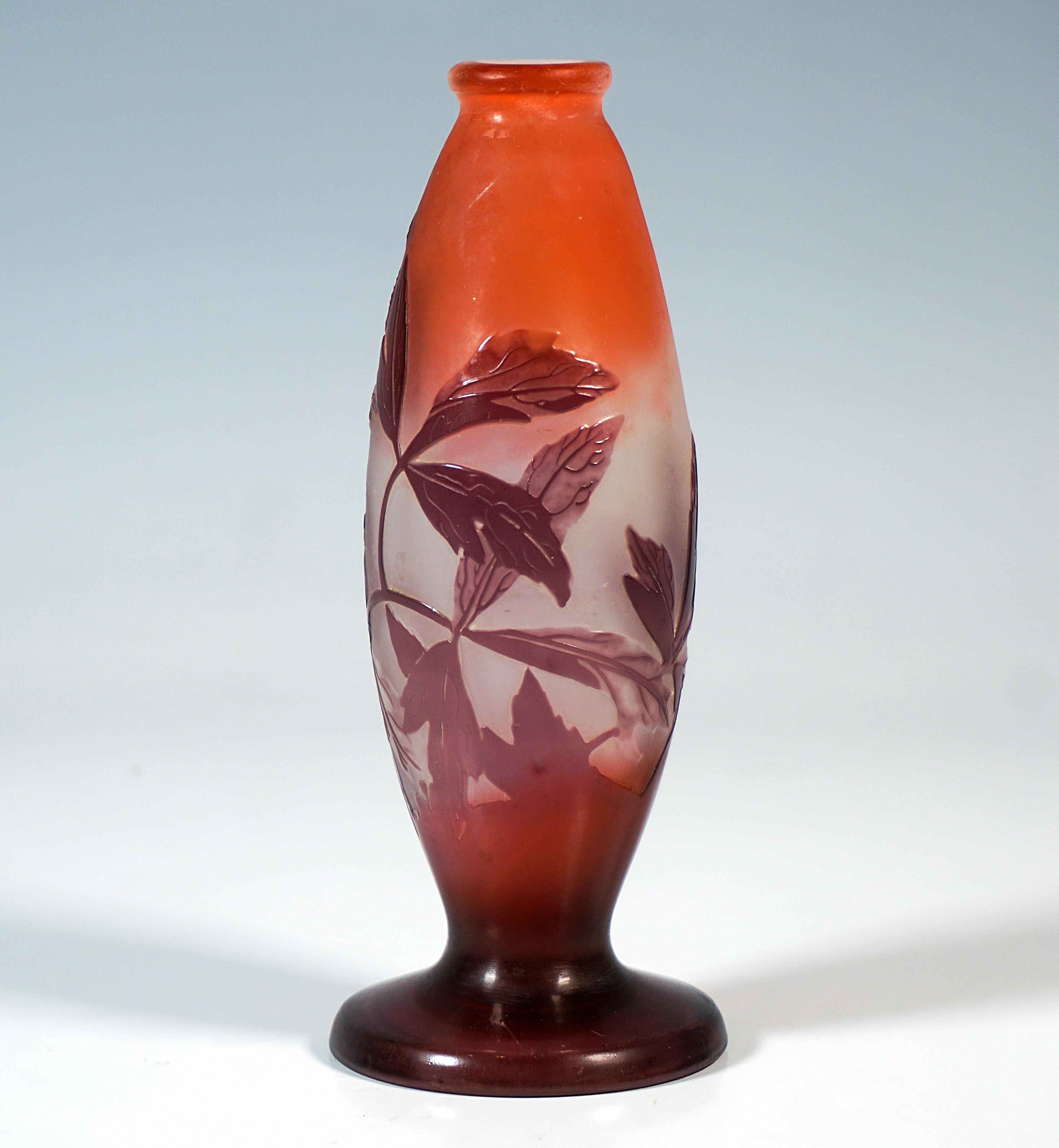 Spindle-shaped solitary vase on a round foot, slightly outwardly flared, beaded rim above a narrow neck constriction, colorless glass with milky white and reddish powdered inclusions, overlay in burgundy red, highly 
etched anemone decoration