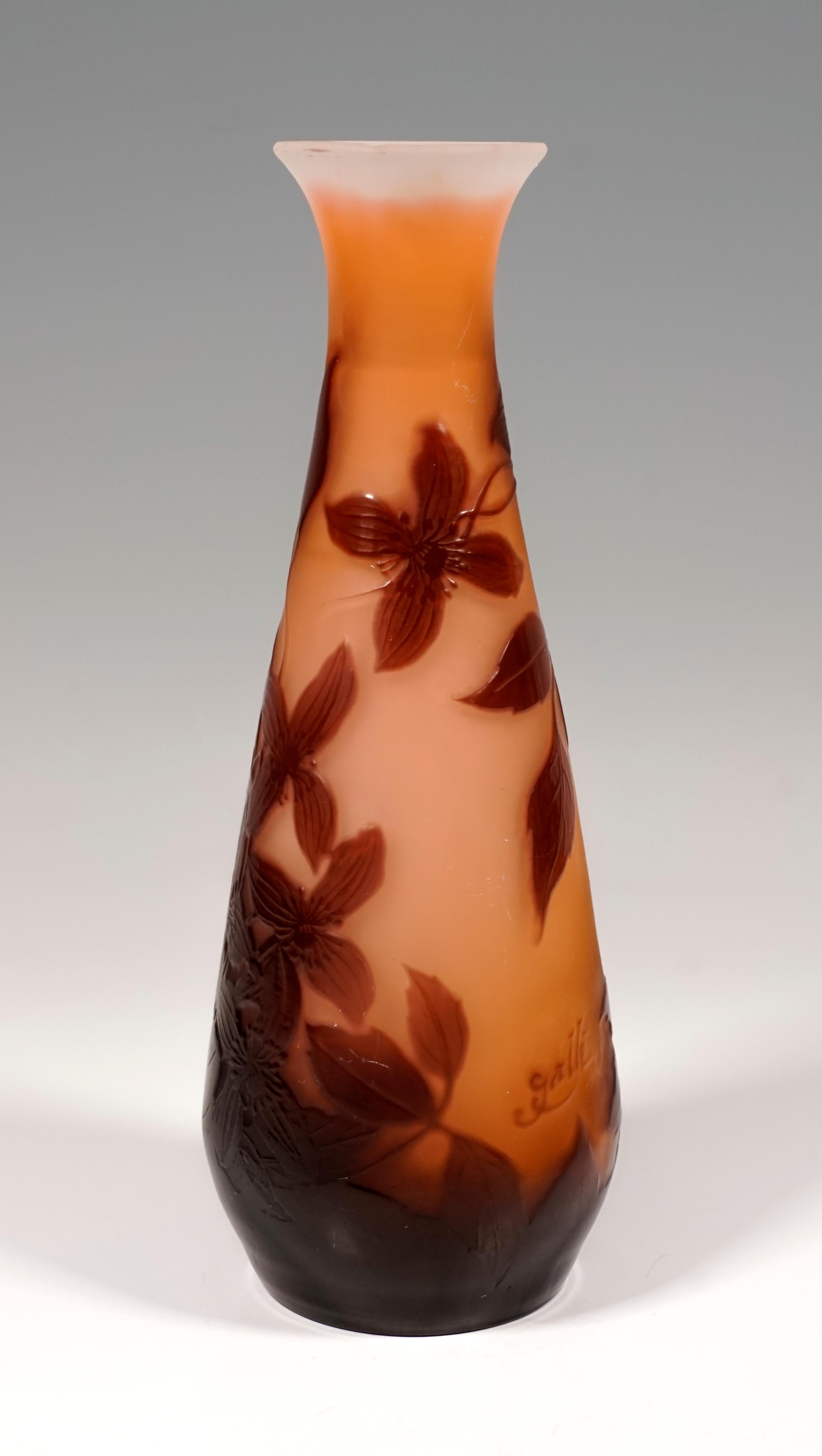 Vase in the form of a flacon: slightly bulged body, tapering towards the top, narrow opening, widening to the flared rim of the mouth. The area close to the floor is completely covered in burgundy red, above the etched decor with clematis in front