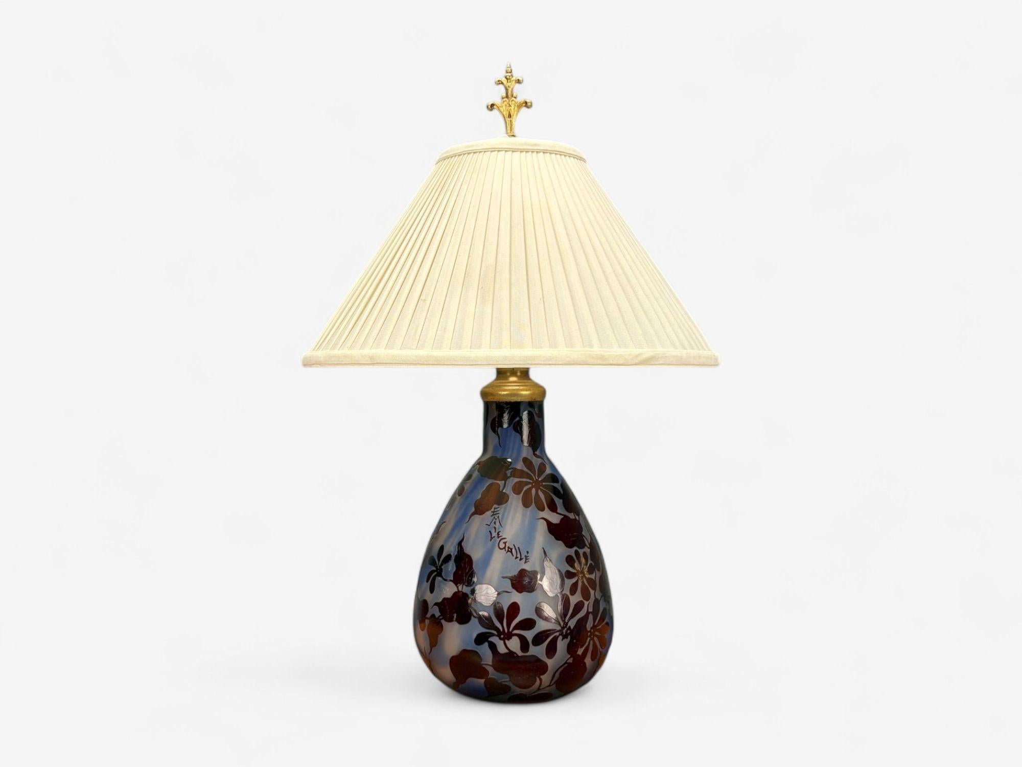 Emile Gallé, French Art Nouveau, Decorated Glass, Brass, Table Lamp, France, 1920s

A French Art Nouveau table lamp designed by Emile Gallé (1846-1904) in early 20th century France. This example presents with a wonderful deep blue/purple
