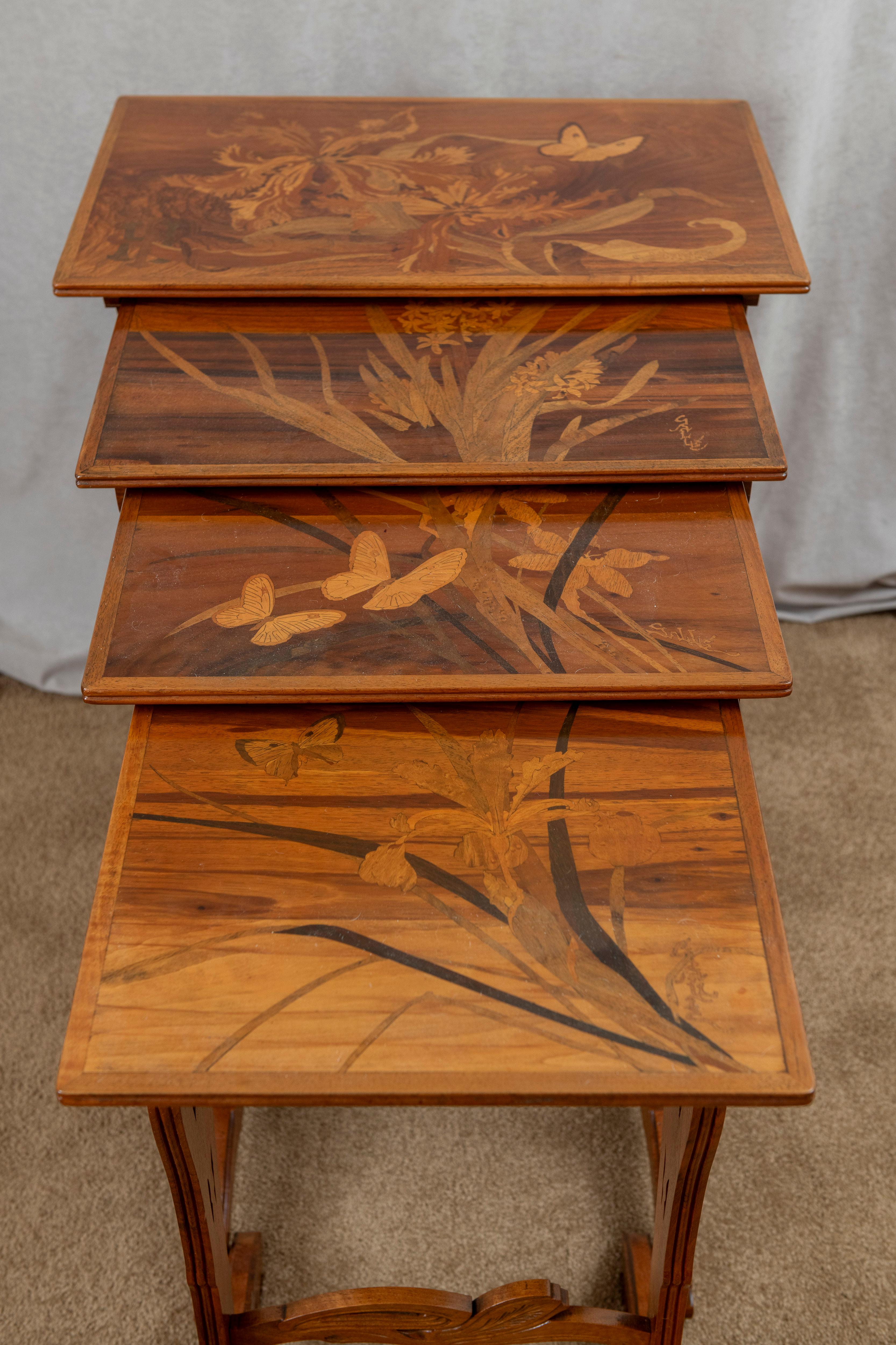   These fabulous art nouveau period tables were made by the noted French artist Emile Gallé. Known for his beautiful glass works and his furniture, his commitment to quality is easy to spot. The marquetry on these tables is colorful and organic.