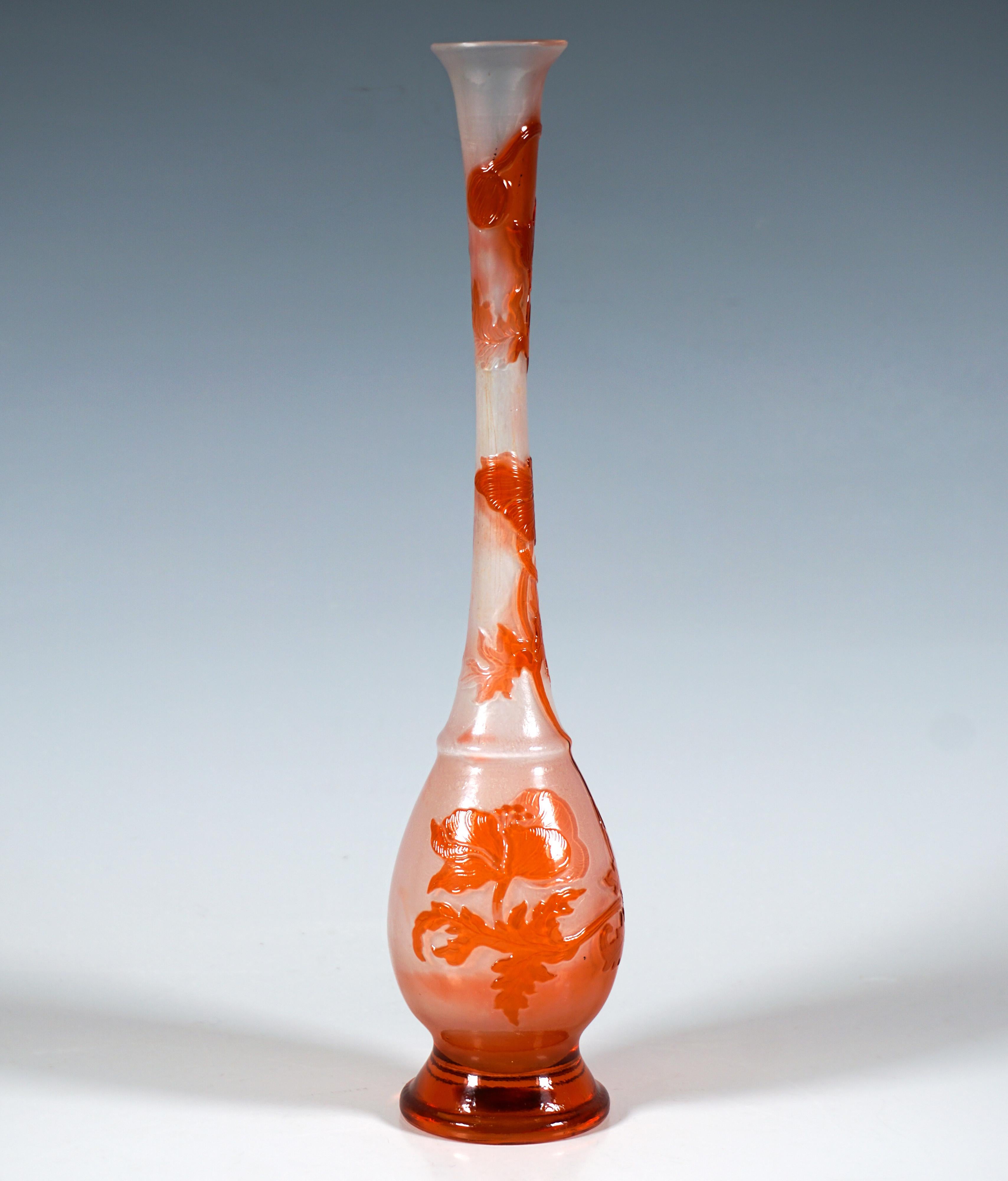 Solitary vase in the shape of a drop: bulbous body on a round, stepped base, narrowing as it rises and widening again to a bulging expansion to form a long, slender neck, widening again towards the trumpet-shaped flared mouth, clear glass with white