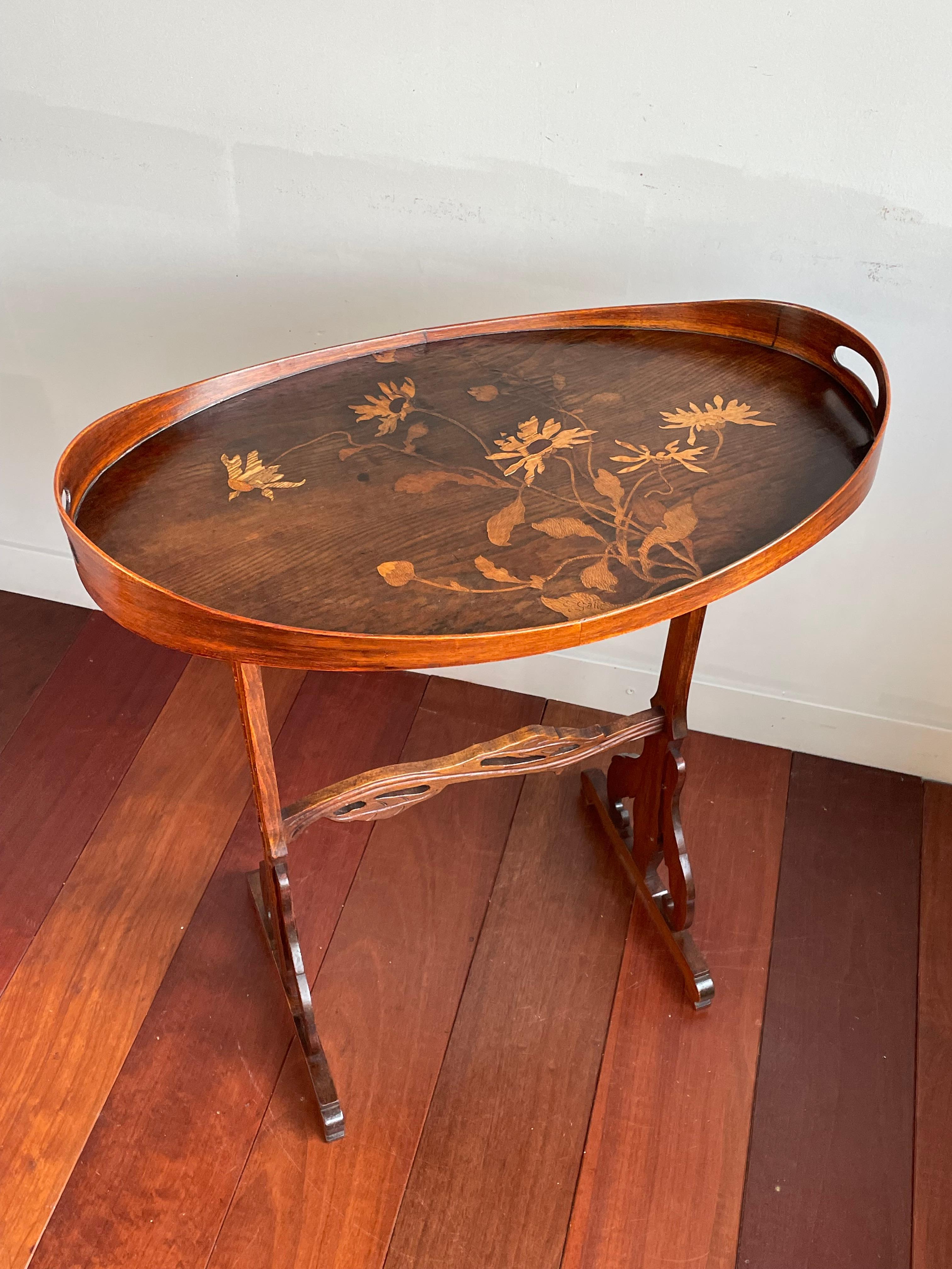 Beautiful and practical Art Nouveau table by one of the French master designers.

This elegant and remarkable condition table in the Art Nouveau style is entirely made of beautiful woods and the inlaid floral patterns most connoisseurs will