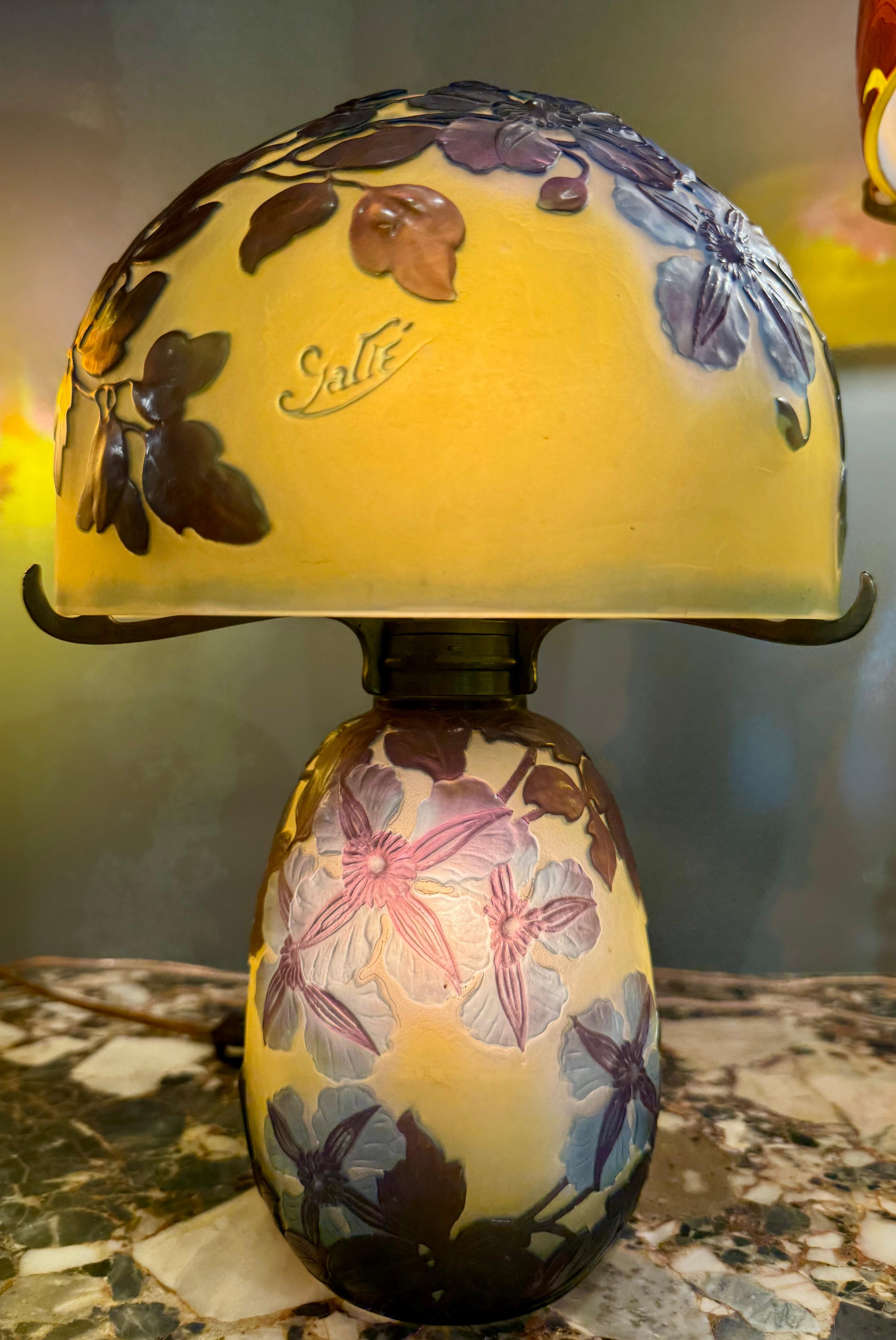 Exquisite Émile Gallé “Clematis” Table Lamp, ca. 1900

An extraordinary example of French Art Nouveau glass artistry, this Clematis table lamp by Émile Gallé (1846–1904) features a richly modeled cameo glass shade and matching base, both beautifully