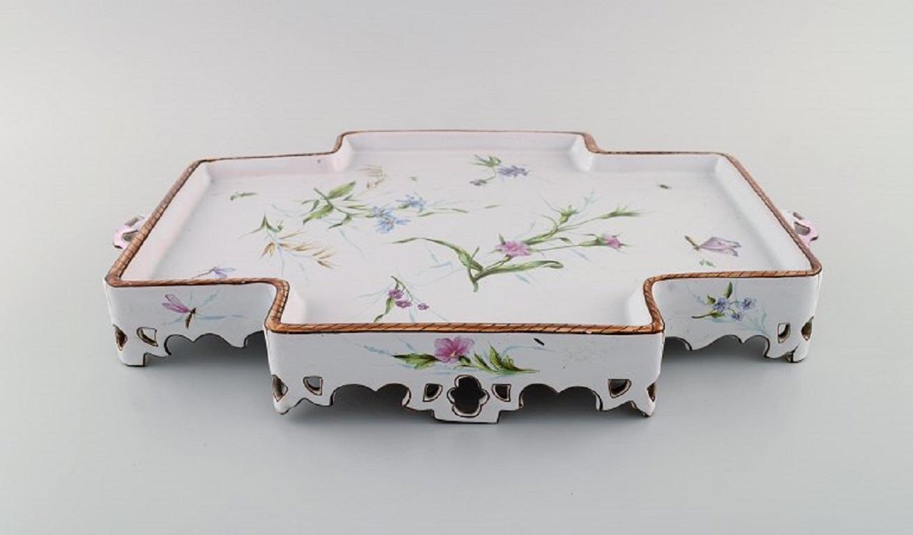 Emile Gallé for St. Clement, Nancy. 
Large and rare serving tray with handles. Hand-painted faience with flowers and butterflies. 
1870s / 80s.
Measures: 42 x 28 x 6 cm.
In excellent condition. One small repair.
Signed.
