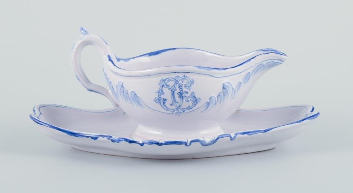 Emile Gallé for St Clement, Nancy. 
Sauce boat on base in hand-painted earthenware. Decorated with flowers.
1870s/80s.
In perfect condition. Appears unused.
Signed.
Dimensions: L 24.0 cm. x H 10.0 cm.