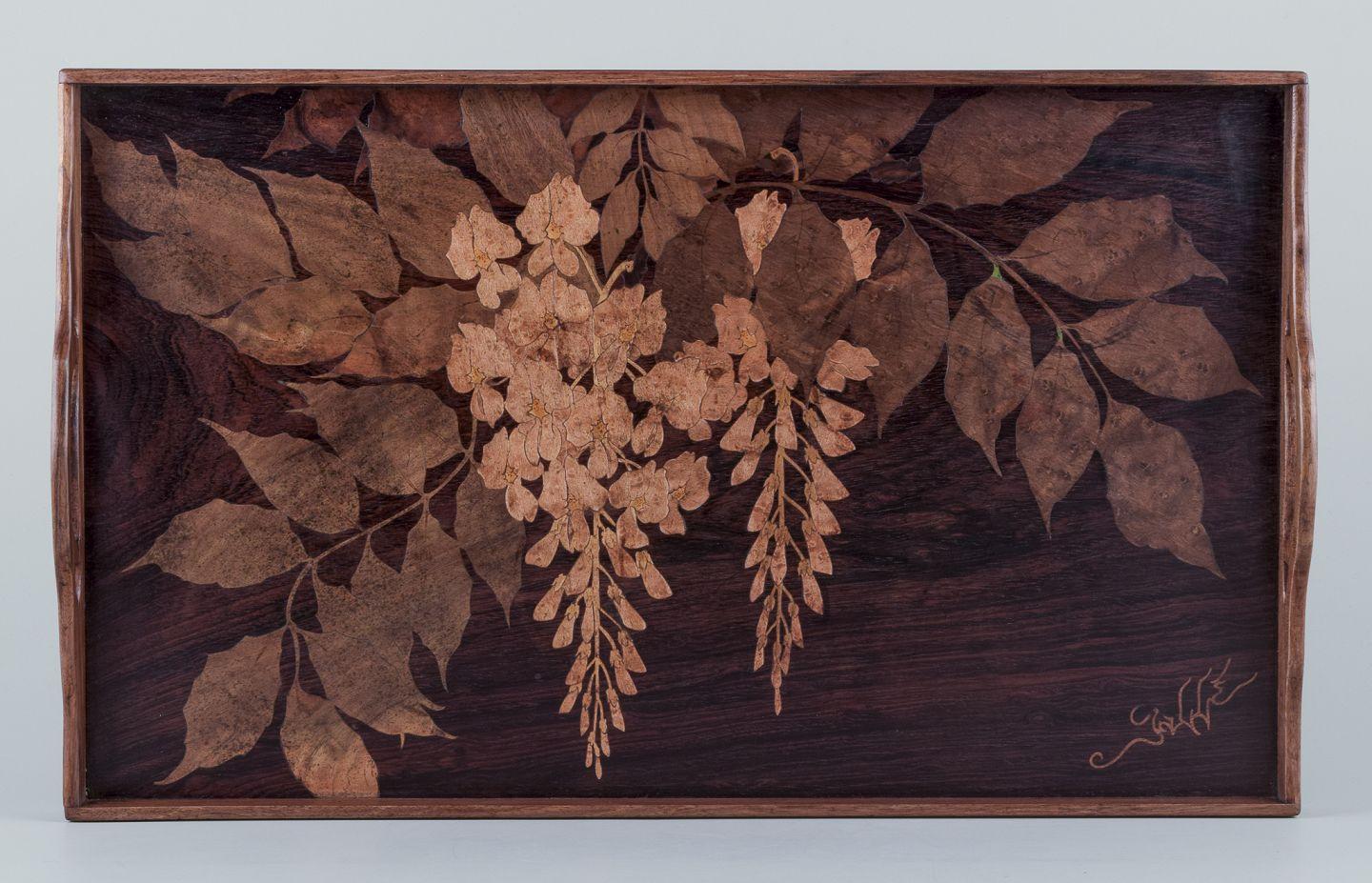 Emile Gallé (1846-1904), French glass artist and designer. 
Large tray in fruitwood. Inlaid with floral motifs in different types of wood.
Late 1800 century.
Signed.
In perfect condition.
Dimensions: L 51.0 cm. x D 31.0 cm. x H 6.0 cm. including