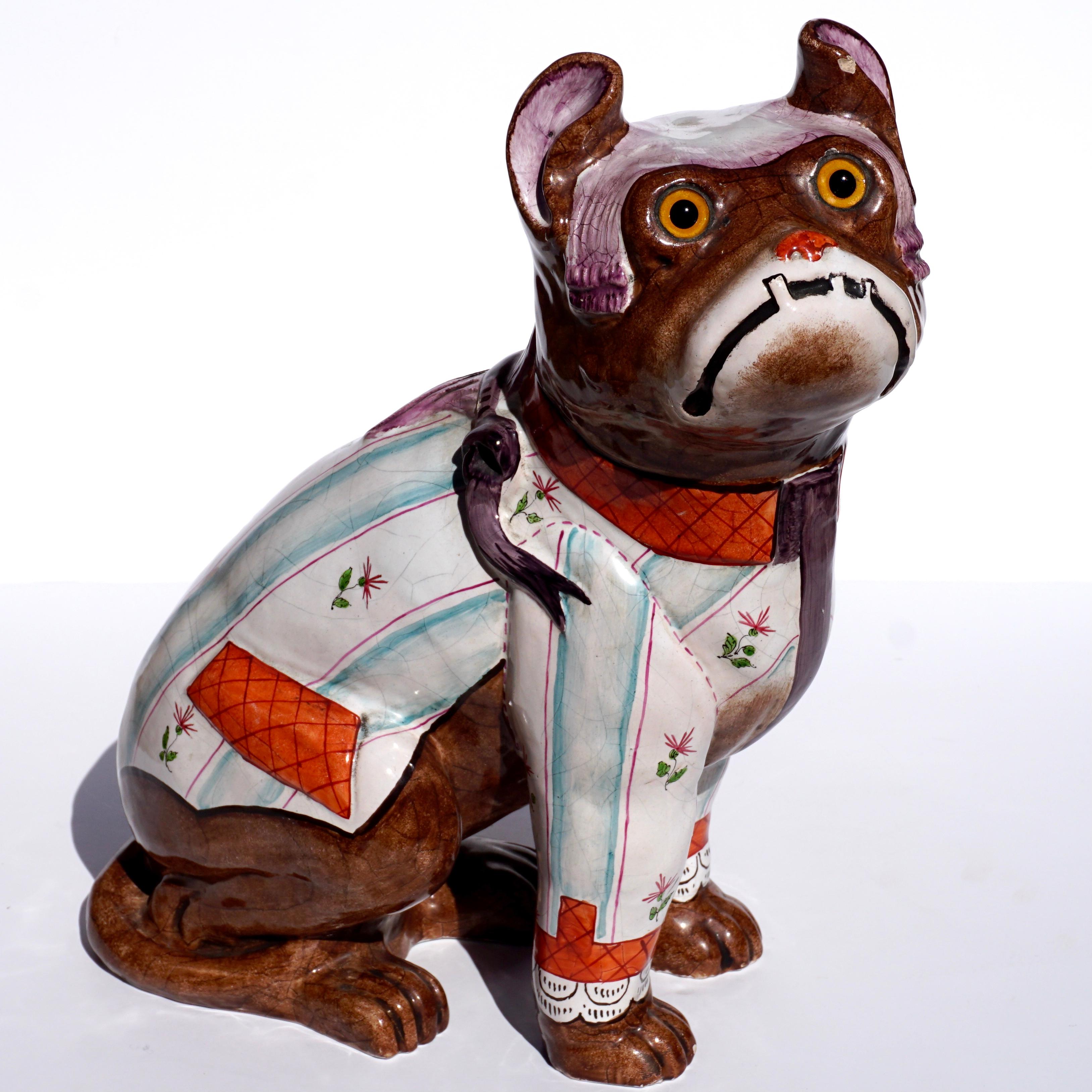Emile Galle (1847 - 1904) Faience Tin Glazed Pottery Figure of A Dog.

A whimsical French bull dog dressed in a formal tail coat and political wig with signature Galle glass eyes. The coat stitched with a floral design on striped blue and white