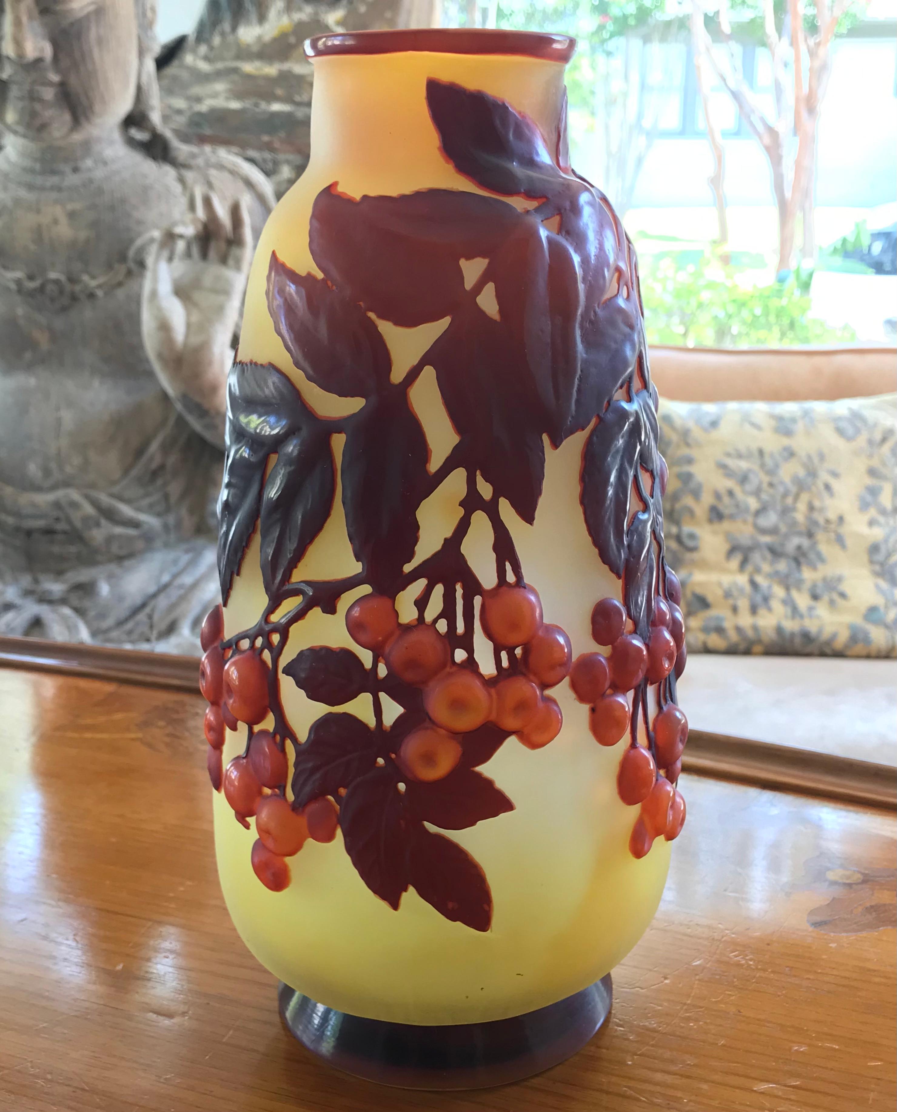 Galle Mold-blown cameo glass art nouveau vase with beautiful red rowan berries in bunches on a branch with leaves, A formidable and large vase with a wonderful yellow glowing frosted background.

France, c. 1910

Height: 11.5  x 5.75 diameter  (29 x