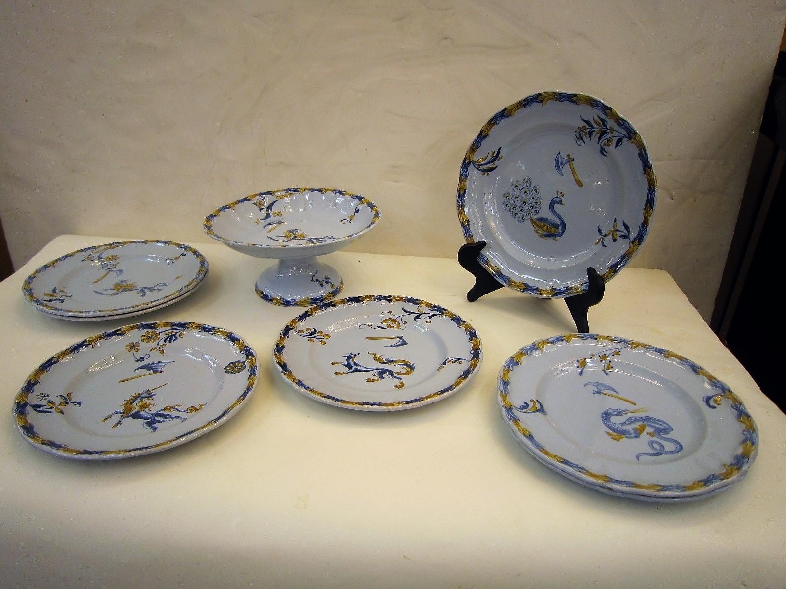 An unusual serving set of seven plates and one compote / footed centrepiece by Emile Galle.
Each piece of antique Faience earthenware is hand signed and numbered E. Galle, Nancy
These hand-painted dishes have scalloped decorative borders in blues