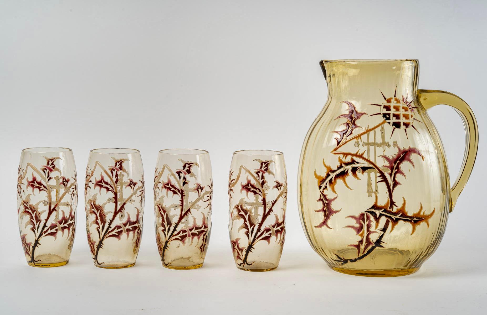 Orangeade set “Chardons” made in amber yellow glass with enamel design of thistles by Émile Gallé.
Each piece is signed “E.Gallé”.

All parts are in perfect condition. The carafe is gadrooned and the glasses are hammered with three points sunk on