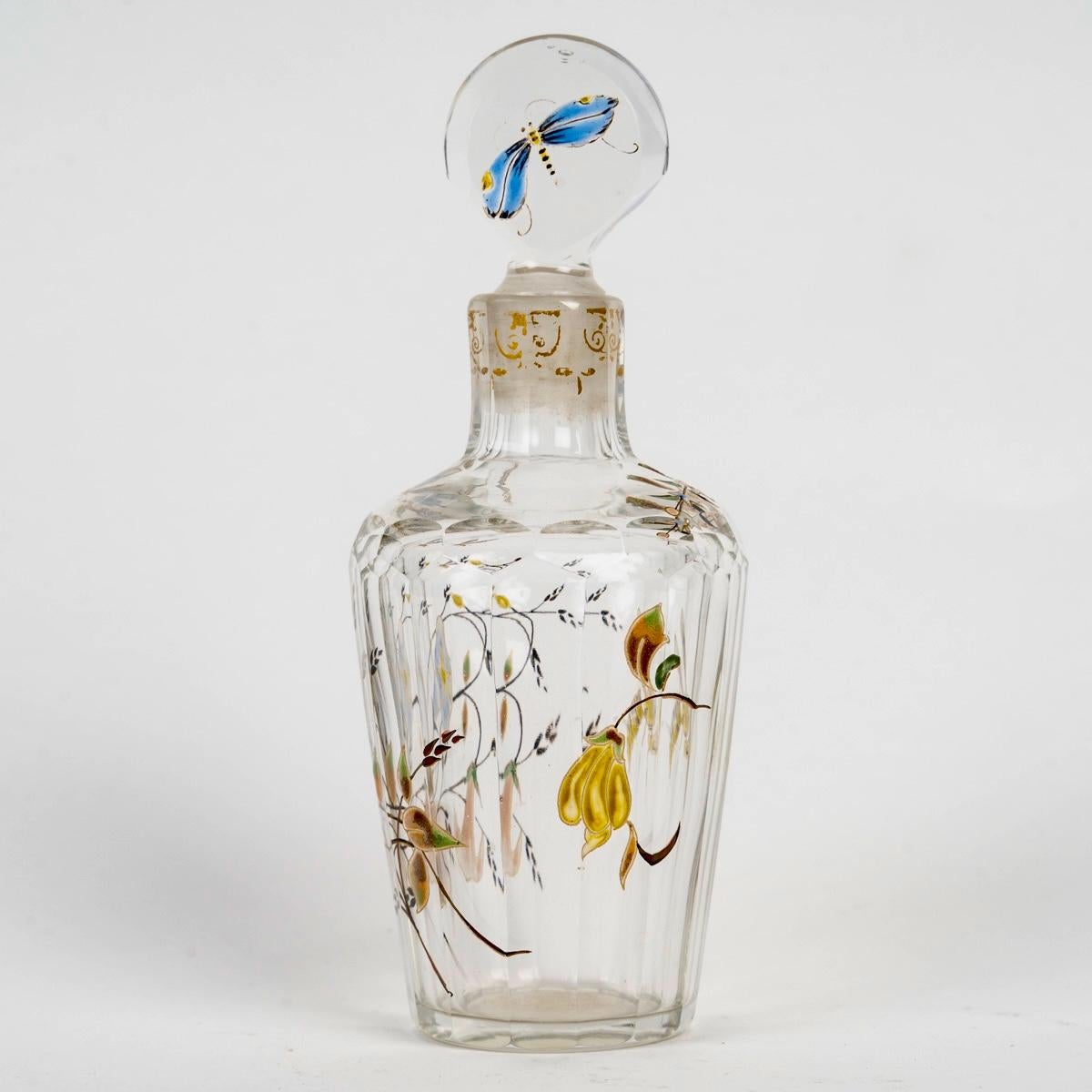 Perfume Bottle made in glass with enamel decoration of a dragonfly and bees among flowers.
Engraved signature.

Perfect condition. Very beautiful enamel.

Height: 12 cm