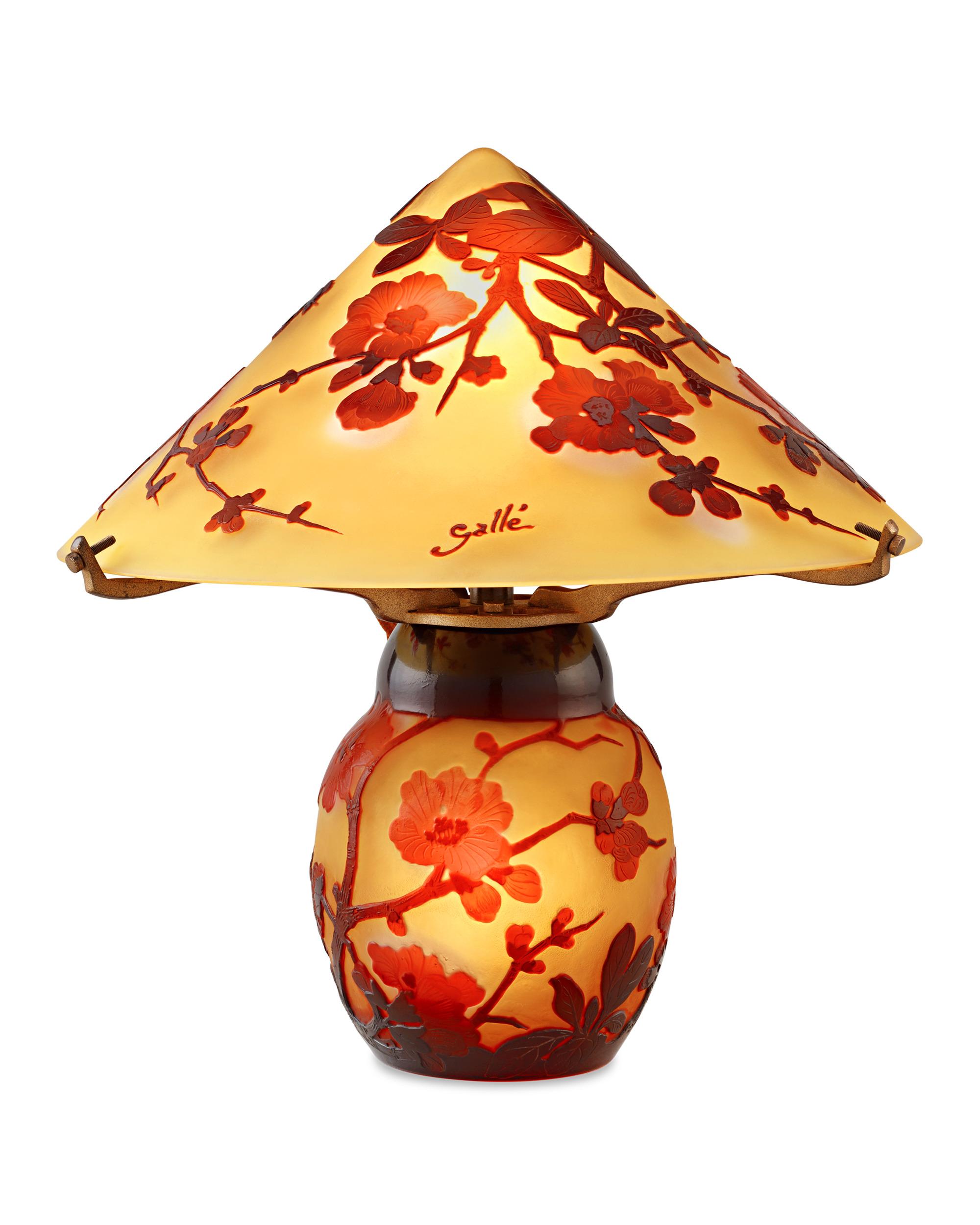 This exquisite lamp by famed Art Nouveau master Émile Gallé illustrates why he remains one of the most highly regarded names in French glassmaking. Delicately etched with a graceful and captivating cherry blossom motif, this beautiful cameo glass