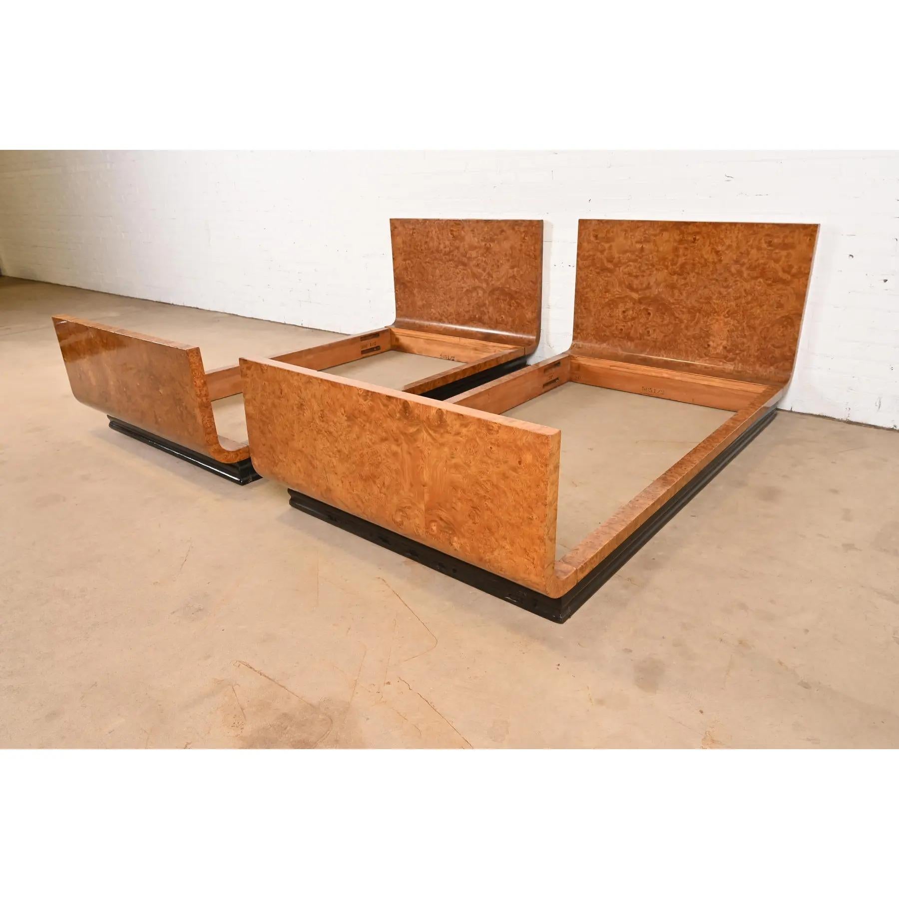 A gorgeous pair of French Art Deco twin beds

In the manner of Émile-Jacques Ruhlmann

France, Circa 1940s

Stunning book-matched burled olive wood, with ebonized wood plinth base.

Each bed measures: 42