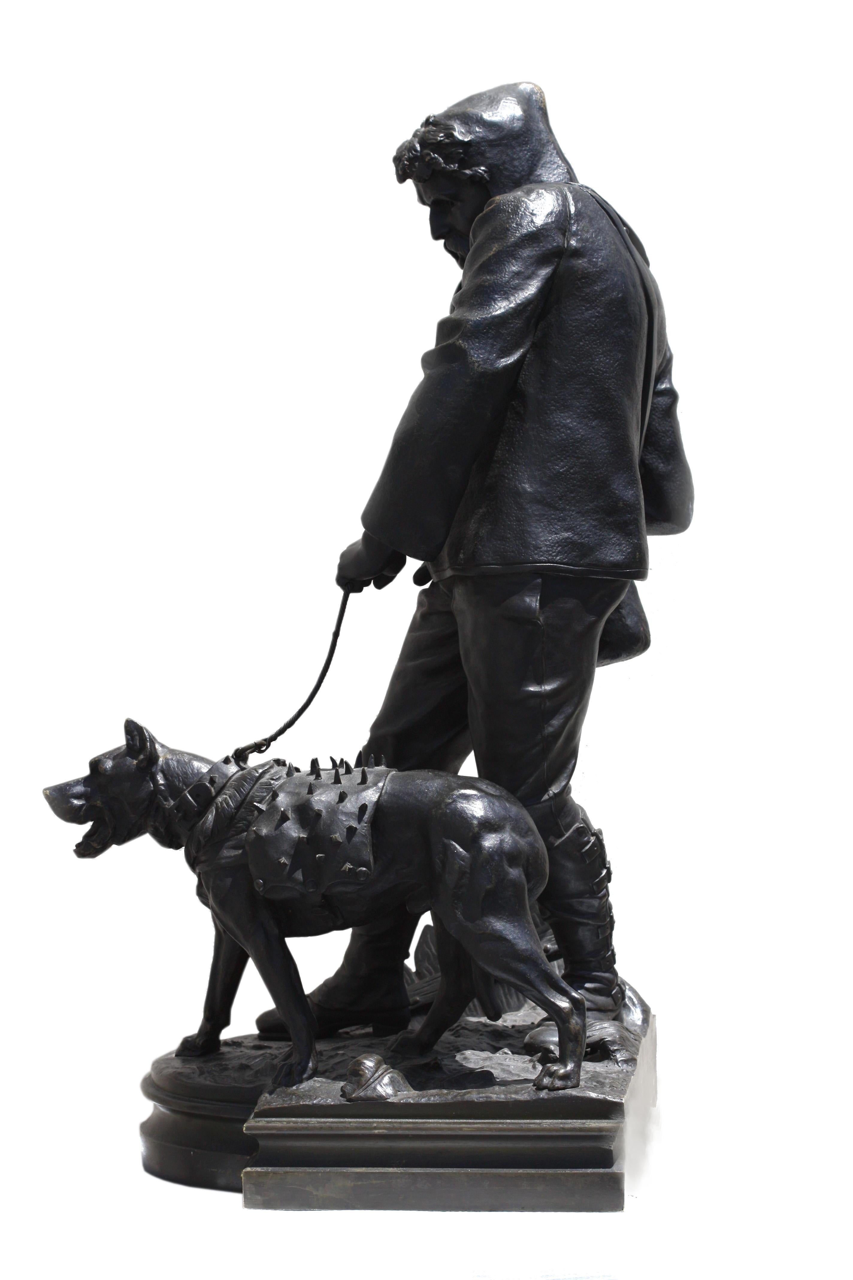 
Emile-Nestor Carlier, (French, 1849-1927), 'Le Chasseur de Loup, (The Wolf Hunter) 
Circa 1900, signed. Patinated bronze. Depicting a hunter in a hooded coat, holding the leash of his dog, wearing a metal studded vest, raised on a shaped plinth,