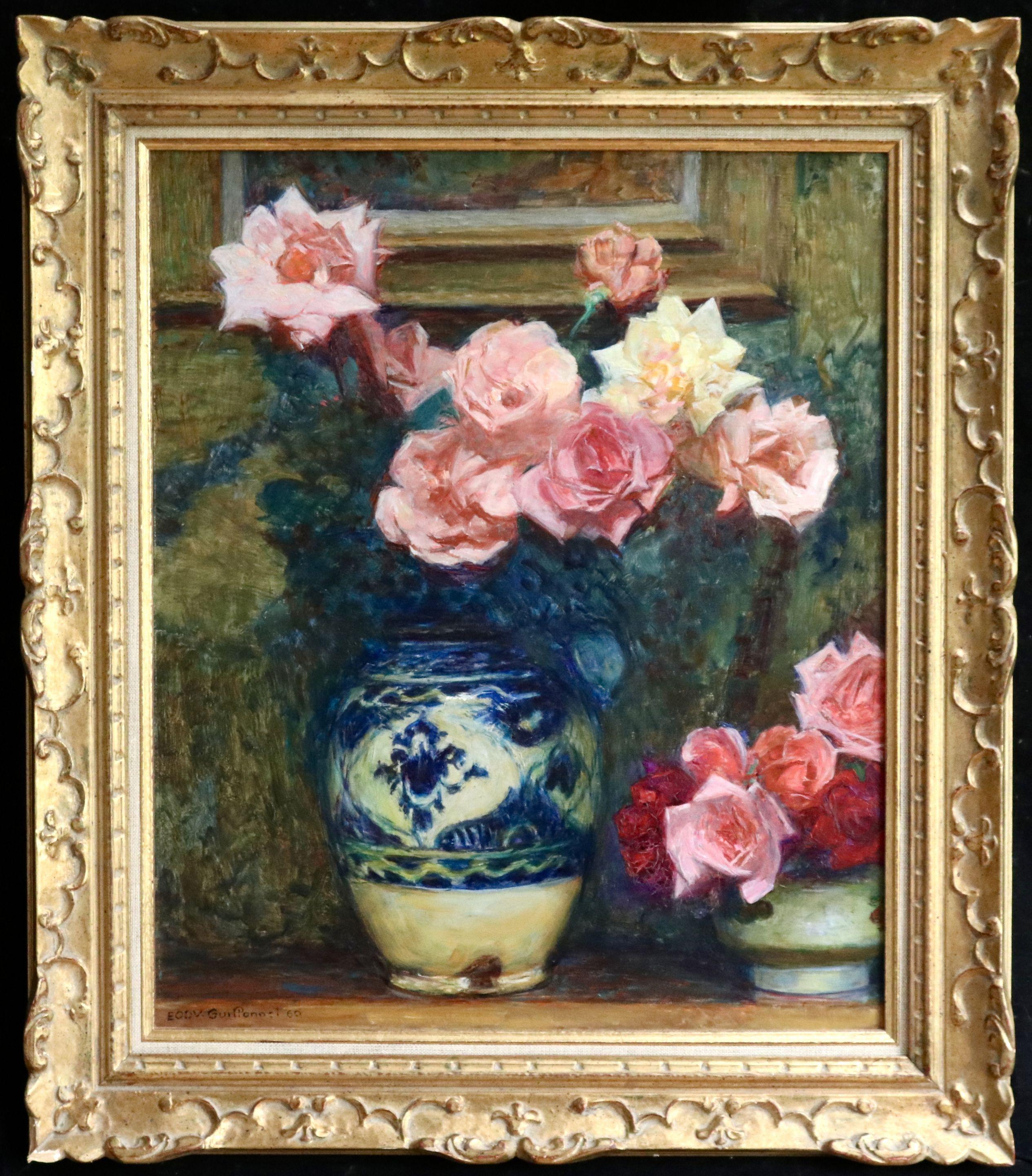 Oil on original canvas by Emile Octave Denis Victor Guillonnet depicting pink roses in a blue and white vase on a table with a frame hanging behind it. Signed lower left and dated 1960. Framed dimensions are 28 inches high by 24 inches wide.

Émile