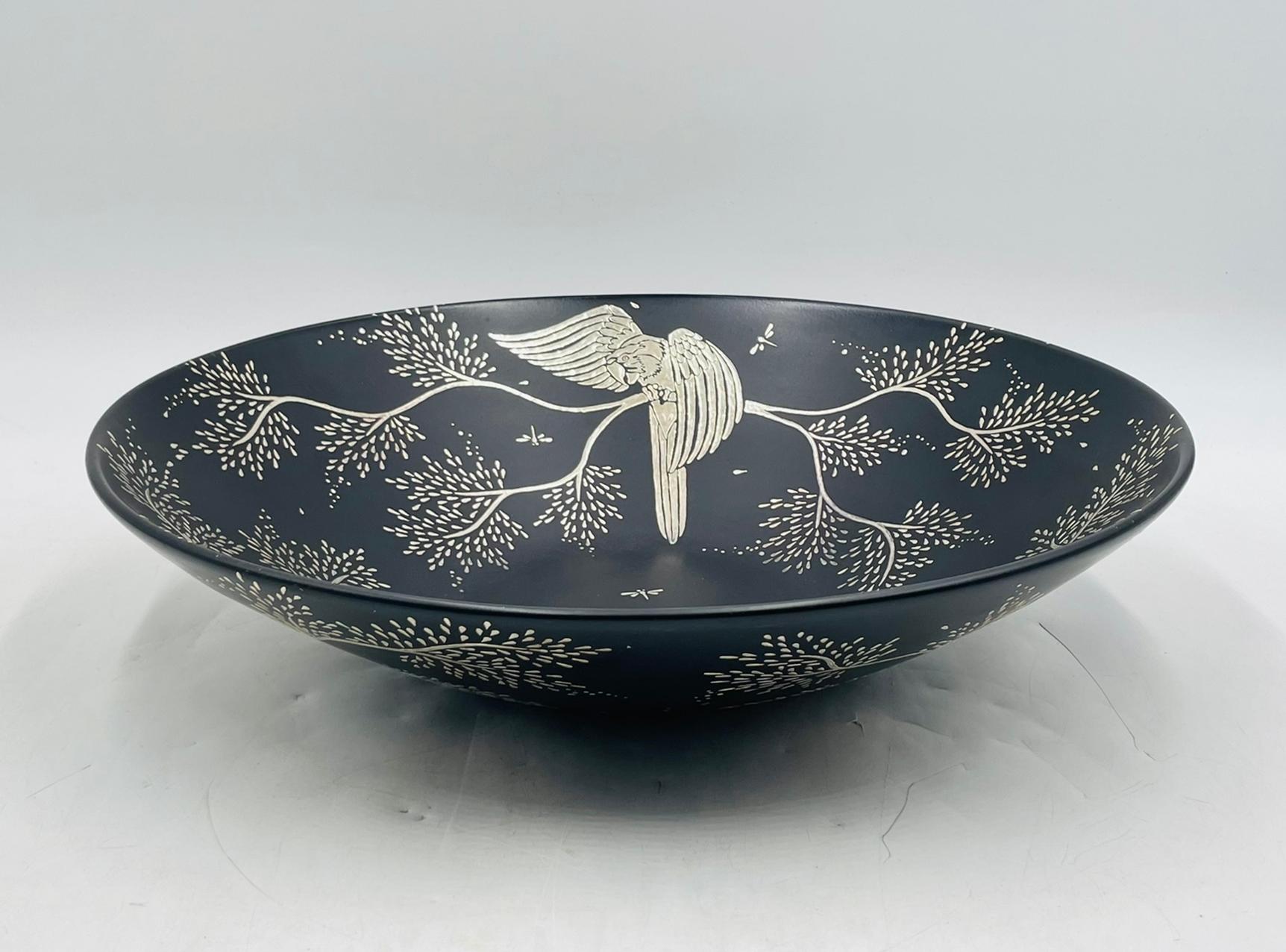 A captivating decorative bowl by renowned Mexican designer Emilia Castillo, handcrafted in black porcelain and intricately inlaid with pure silver. This generously scaled piece features a sweeping botanical design of leafy branches and dragonflies,