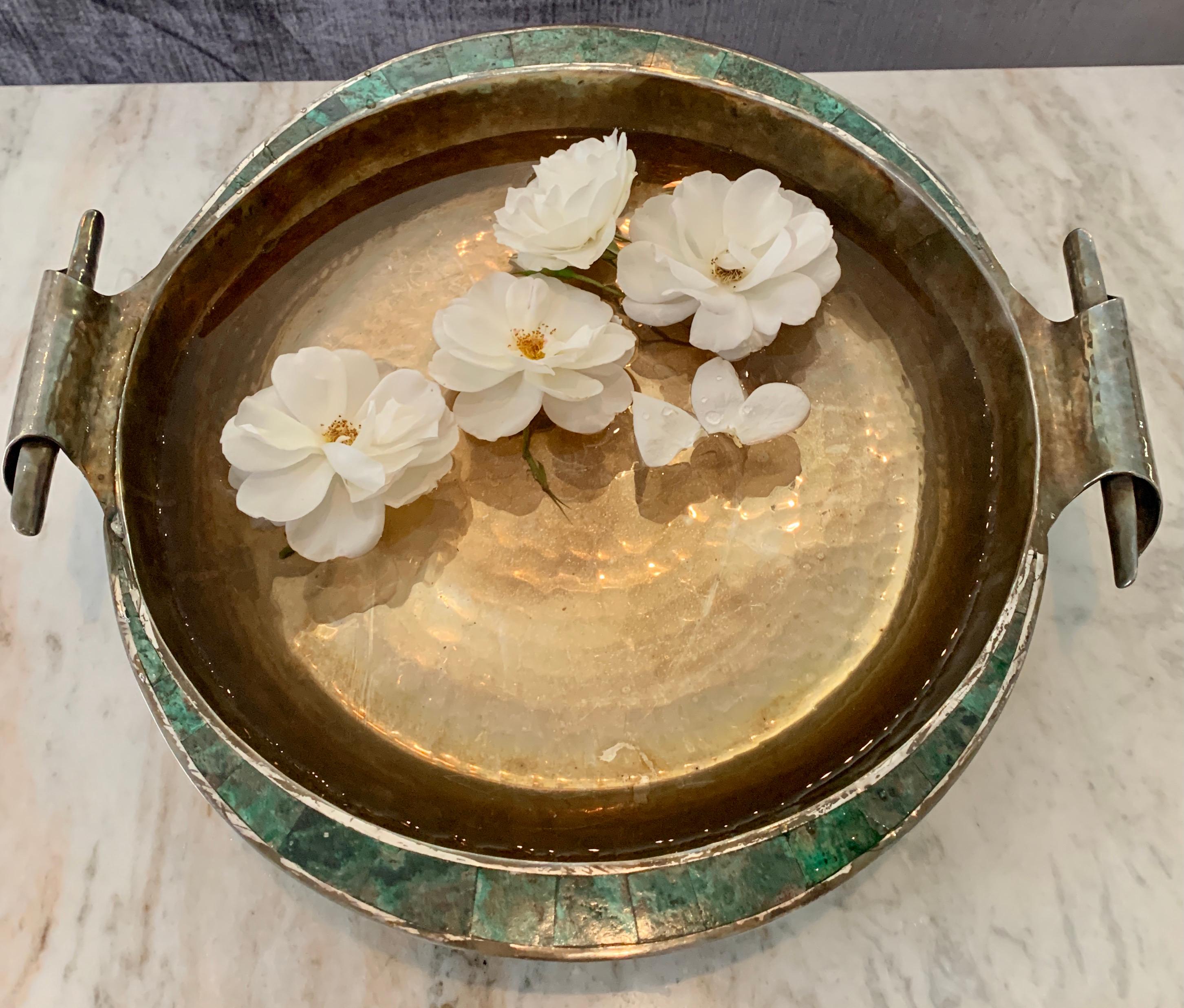 Hand made Mexican sterling bowl with scrolled handles and rim of tessellated green stone or malachite. The piece is a very nice 5.6 pound piece, which we have left heavily patinated. The piece has been polished and is a brilliantly dazzling