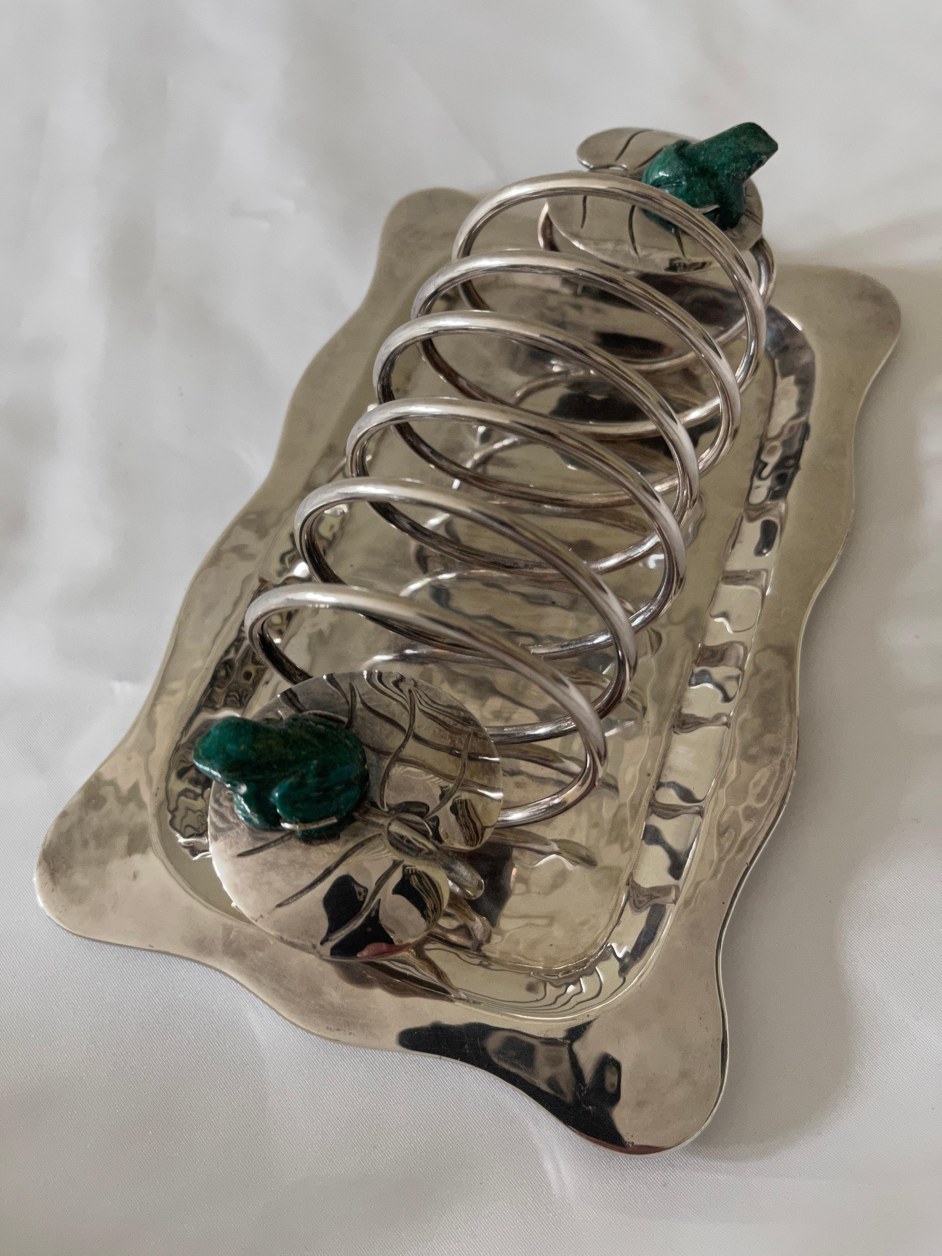 Emilia Castillo lyrically hand wrought Mexican silver plate toast rack with curved edges for breakfast or tea service. Featrures two hand carved malachite frogs sitting on lily pads. 
Signed on bottom corner: EMILIA CASTILLO TO-89 Mexico M.H.