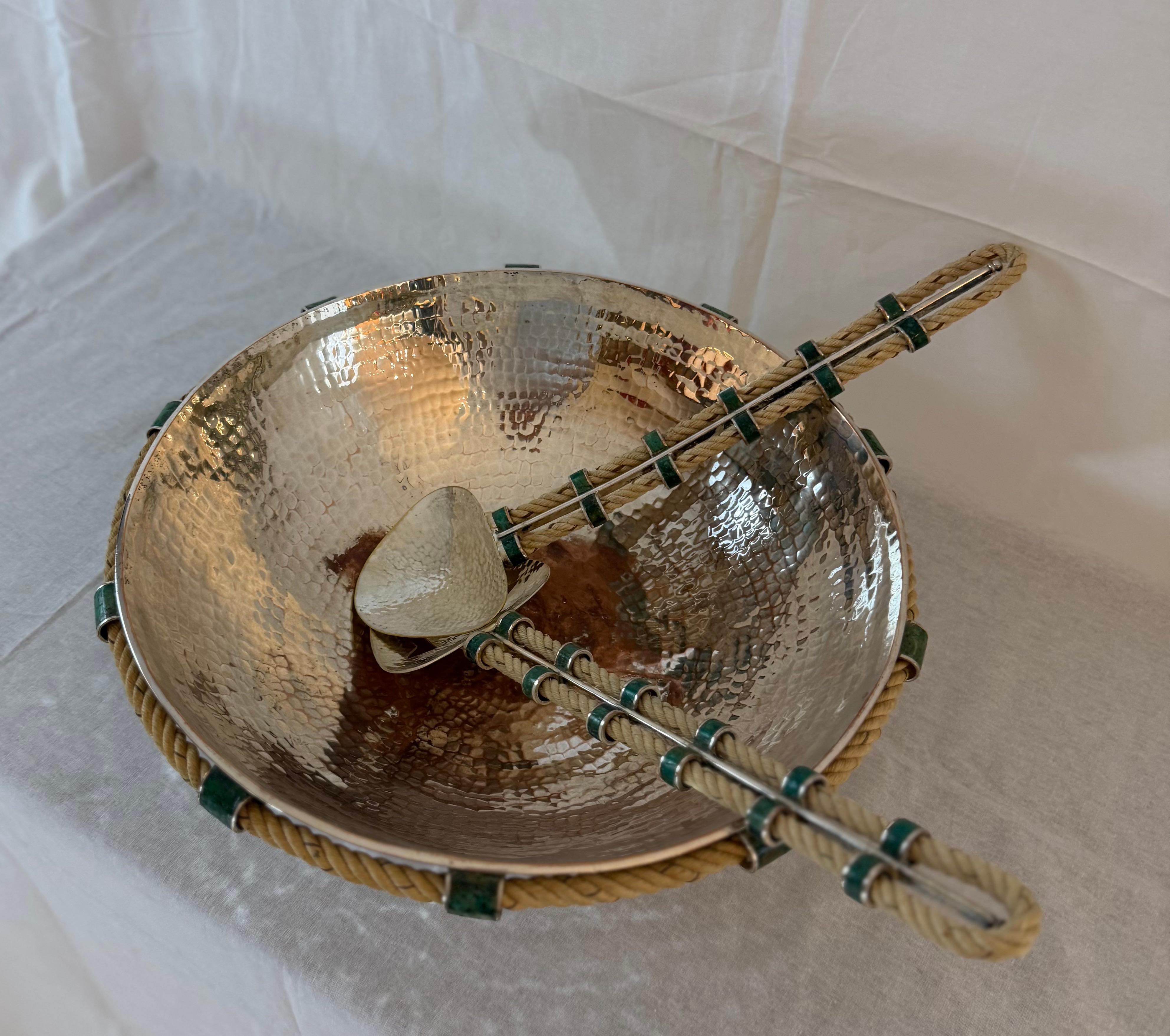 A stunning and substantial hand-hammered silver-plated copper salad bowl with matching serving utensils by Emilia Castillo, renowned Mexican silversmith celebrated for her sculptural and organic designs. The bowl and servers are beautifully detailed