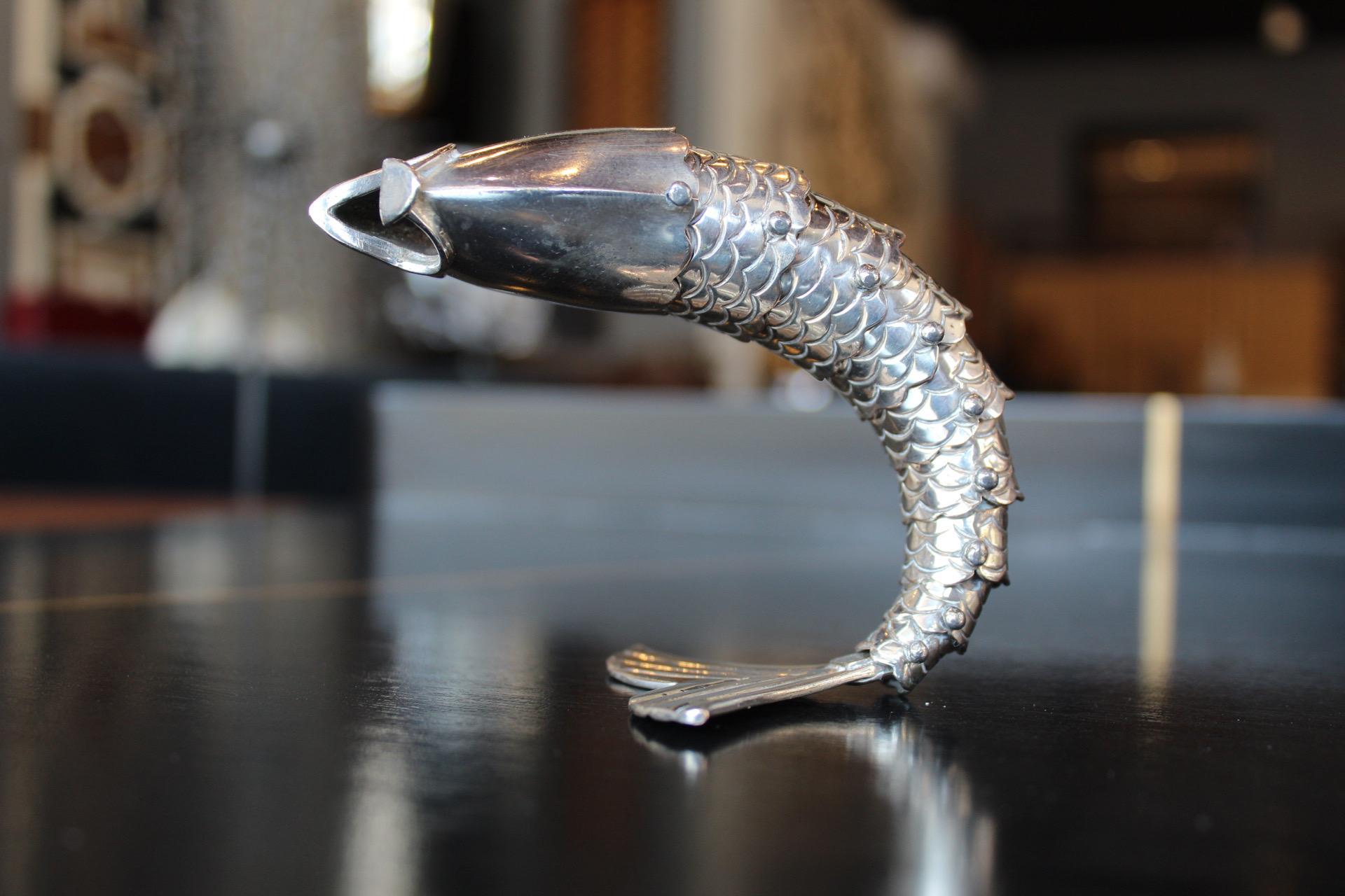 This is an awesome addition to your bar. An articulating fish bottle opener. Piece made by the daughter of Antonio Castillo, a craftsman who developed in the Spratling workshop and left the creative heritage to Emilia.