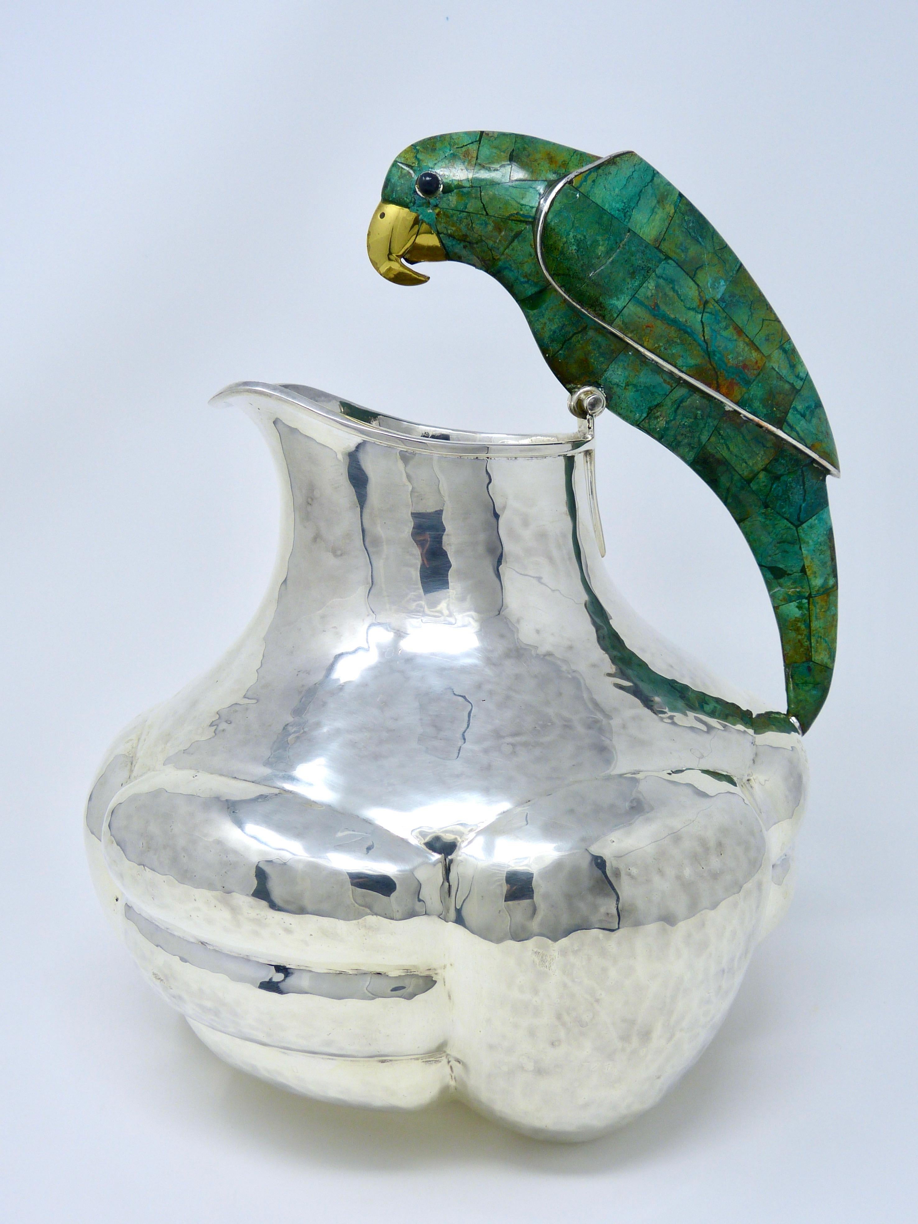 Vintage Emilia Castillo silver plated and malachite water pitcher with parrot
hand-hammered
Made in Taxco, México, late 20th century
Weight 4.47 Lbs.