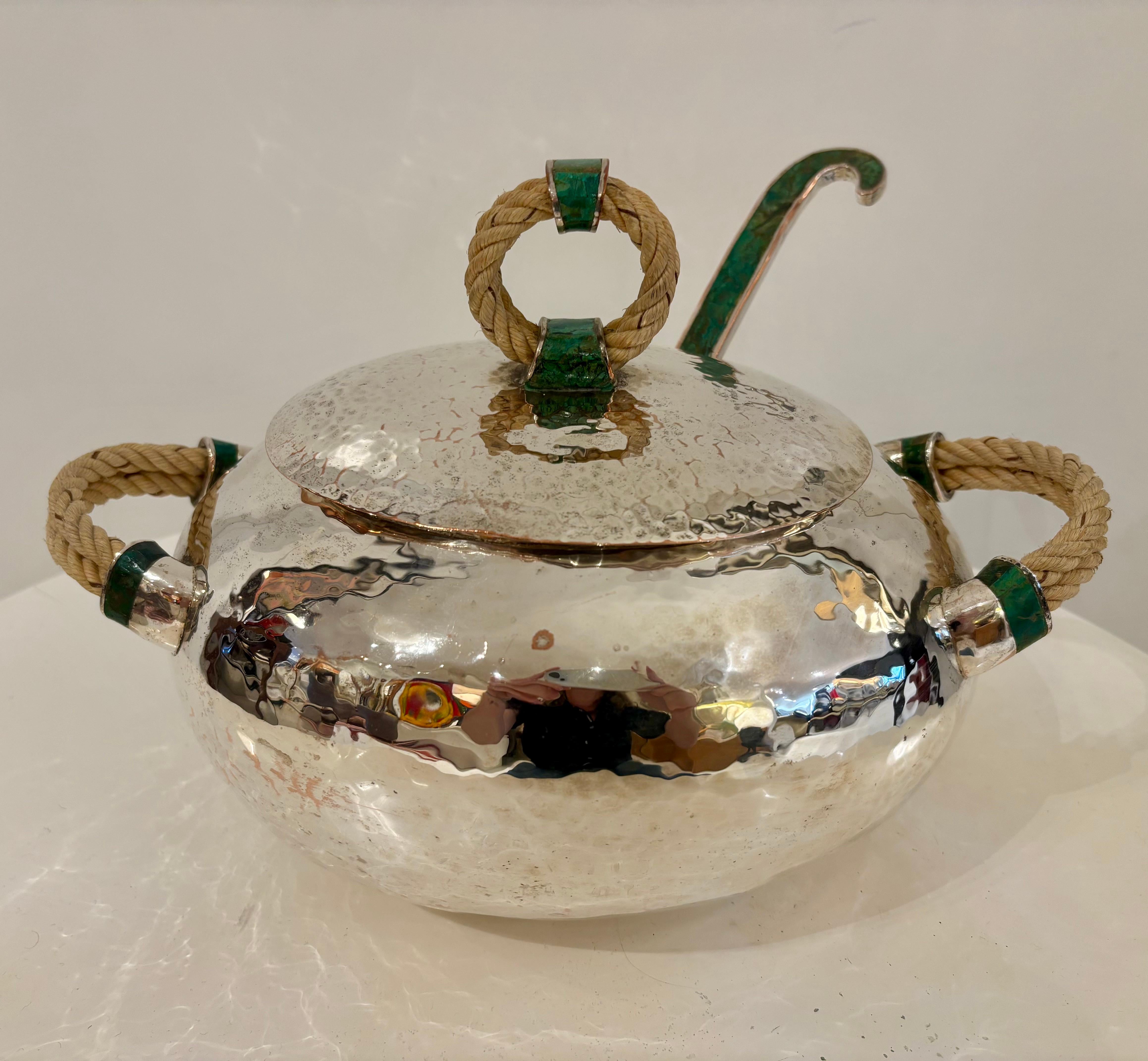 A striking hand-hammered silver-plated copper soup tureen with matching ladle by Emilia Castillo, Mexico, circa 1990s. This elegant lidded vessel exemplifies Castillo’s signature combination of organic form and rich materials—pairing polished silver
