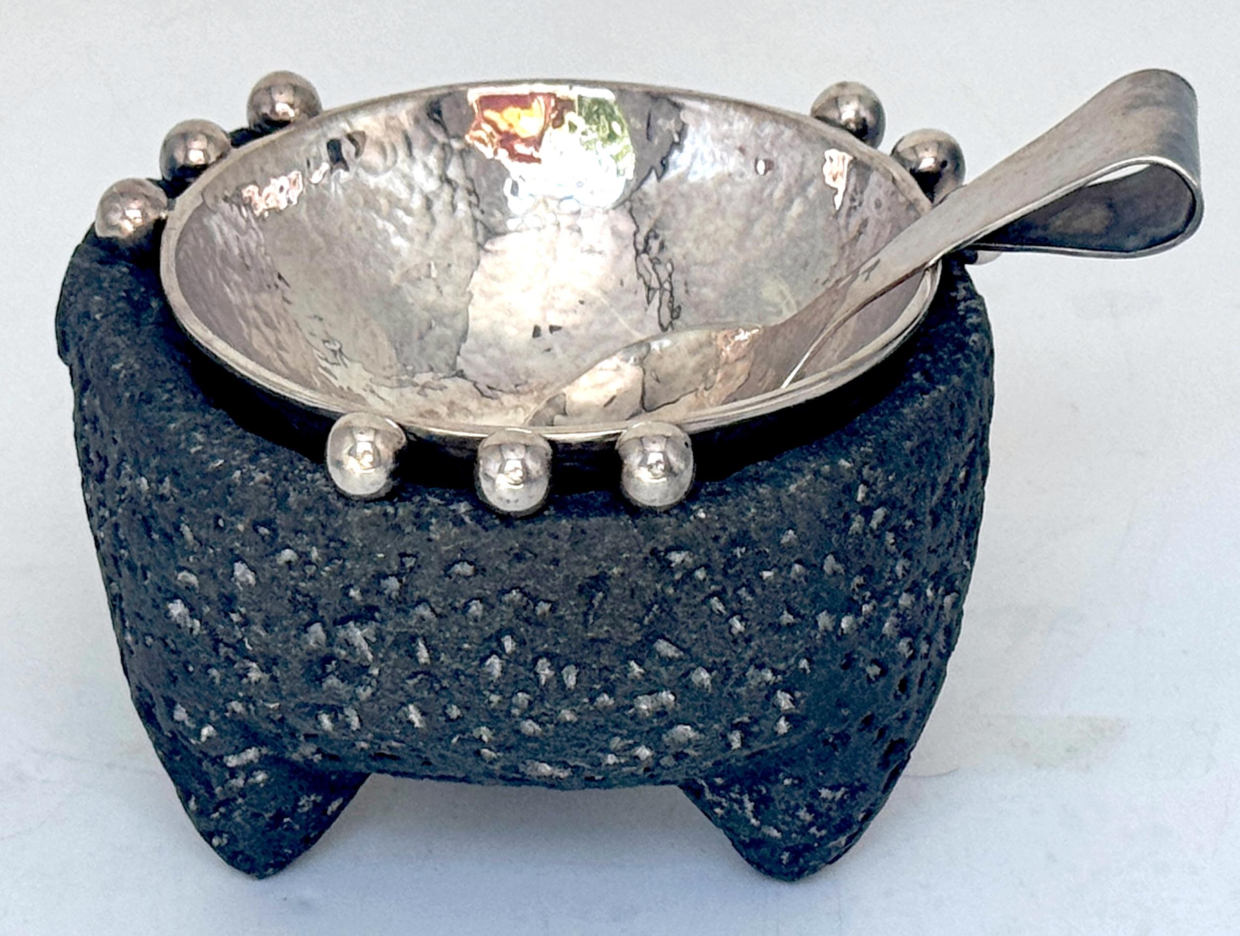 Emilia Castillo Sterling Silver & Volcanic Stone Molcajete with Spoon, Mexico, Later 20th Century 

A sterling silver and volcanic stone molcajete (mortar) set is a functional sculptural object that bridges traditional craftsmanship and modern