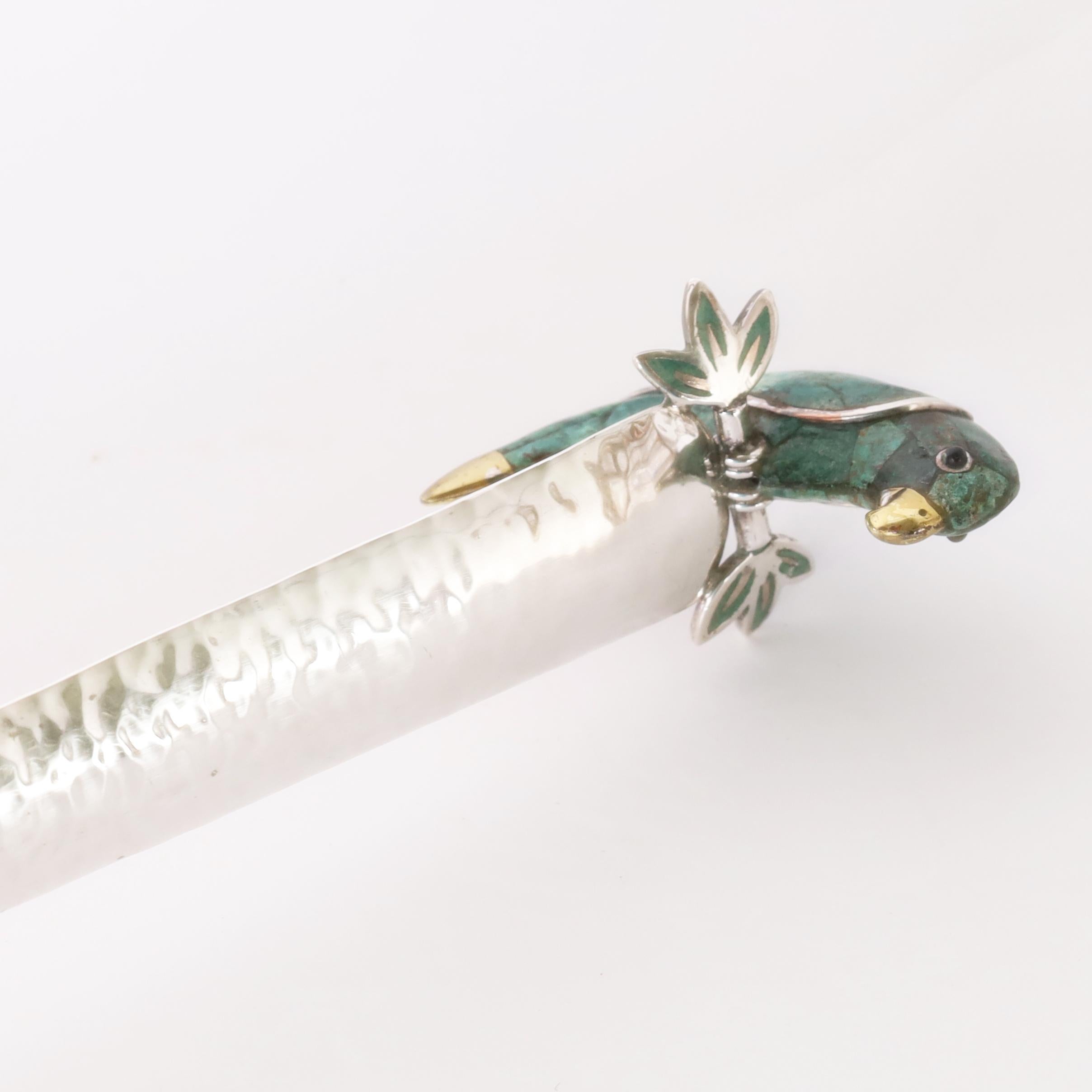 Modern designed serving ladle handcrafted in silver plate on hammered copper featuring a stone clad parrot perched on the top of the handle. Stamped Emilia Castillo Mexico on the handle. 