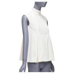 Emilia Wickstead in crêpe crema con pannello frontale plissettato e top peplo con collo alto UK6 XS