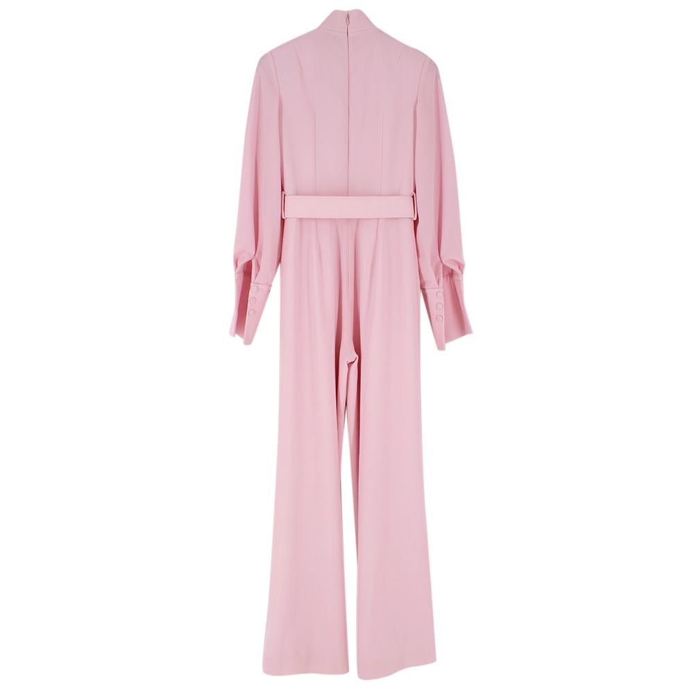 Emilia Wickstead Elvis high-neck belted wool-crepe jumpsuit in a 1970's flared leg style. 

- COLOUR: Light pink
- COMPOSITION: 100% wool
- Lining: 100% polyester
- Made in the UK

Please note, these items are pre-owned and may show signs of being