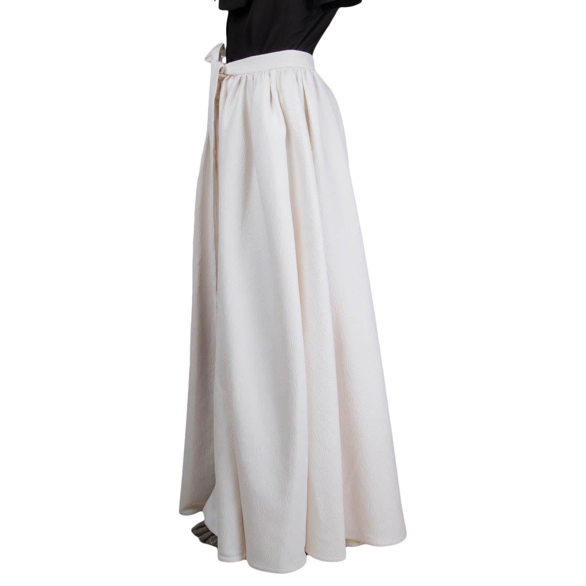 100% authentic Emilia Wickstead 'Sorrento' cloque wrap skirt in off white polyester (73%), polyamid (17%), silk (8%) and elastane (2%). Features an open front and ties at the waist. Fully lined in off-white silk (100%). Brand new, with