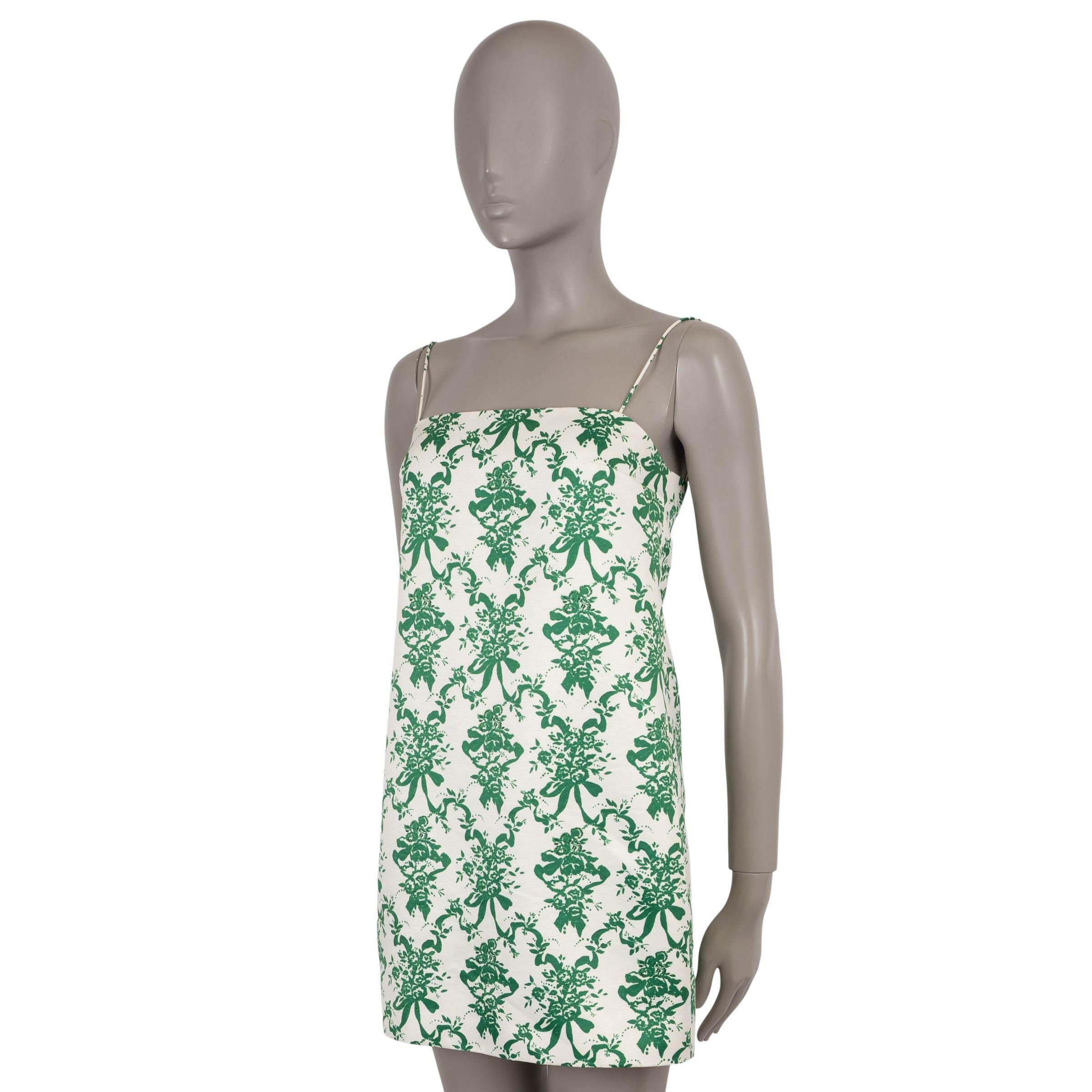 Este minivestido de Emilia Wickstead Miu, 100% auténtico, está confeccionado en poliéster faille blanco roto (100%) con un estampado de rosetas verdes de inspiración Art Déco. La silueta entallada y sin mangas presenta un escote cuadrado con finos