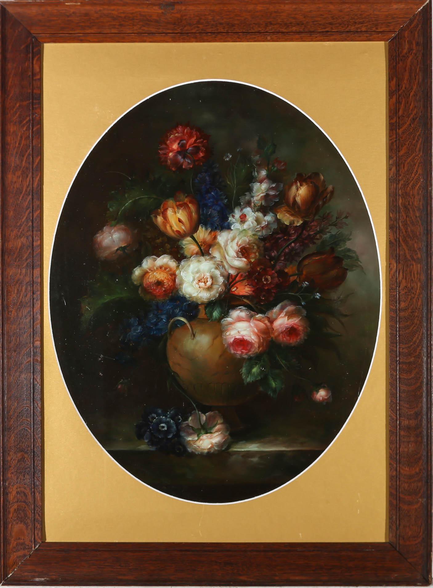 A well composed and delicately painted still life of Tulips, Peonies and Delphiniums, extravagantly displayed in a smooth stoneware urn. Unsigned. Elegantly presented in a dark wood frame with a gilt oval mount. On panel. 
