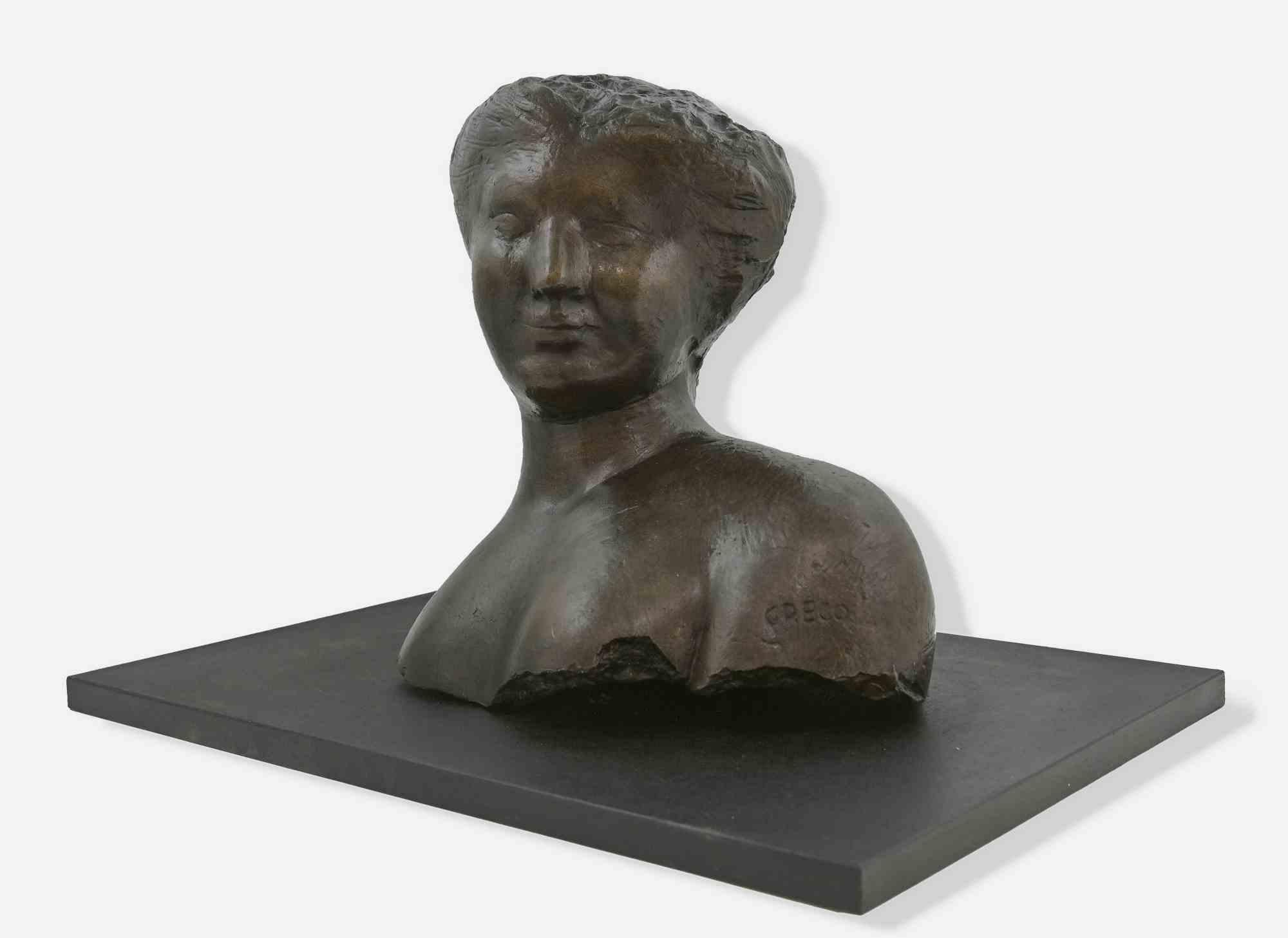 Bust of a woman is a sculpture made by Emilio Greco (1913-1955) in the second half of 20th century. 

Woman with her hair up and a hint of a smile.

The bust is made of bronze with a black wooden base.

 36x39 cm; 38x54 with the black base.