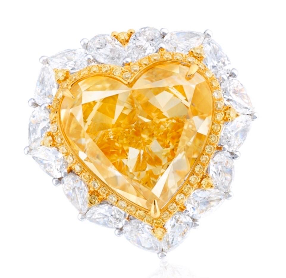 Showcasing a very special Gia certified 10 Carat natural fancy intense yellow diamond in the center. Hand made in the Emilio Jewelry New York Atelier, whom specializes in rare collectible pieces in the Natural ultra rare fancy colored Diamond