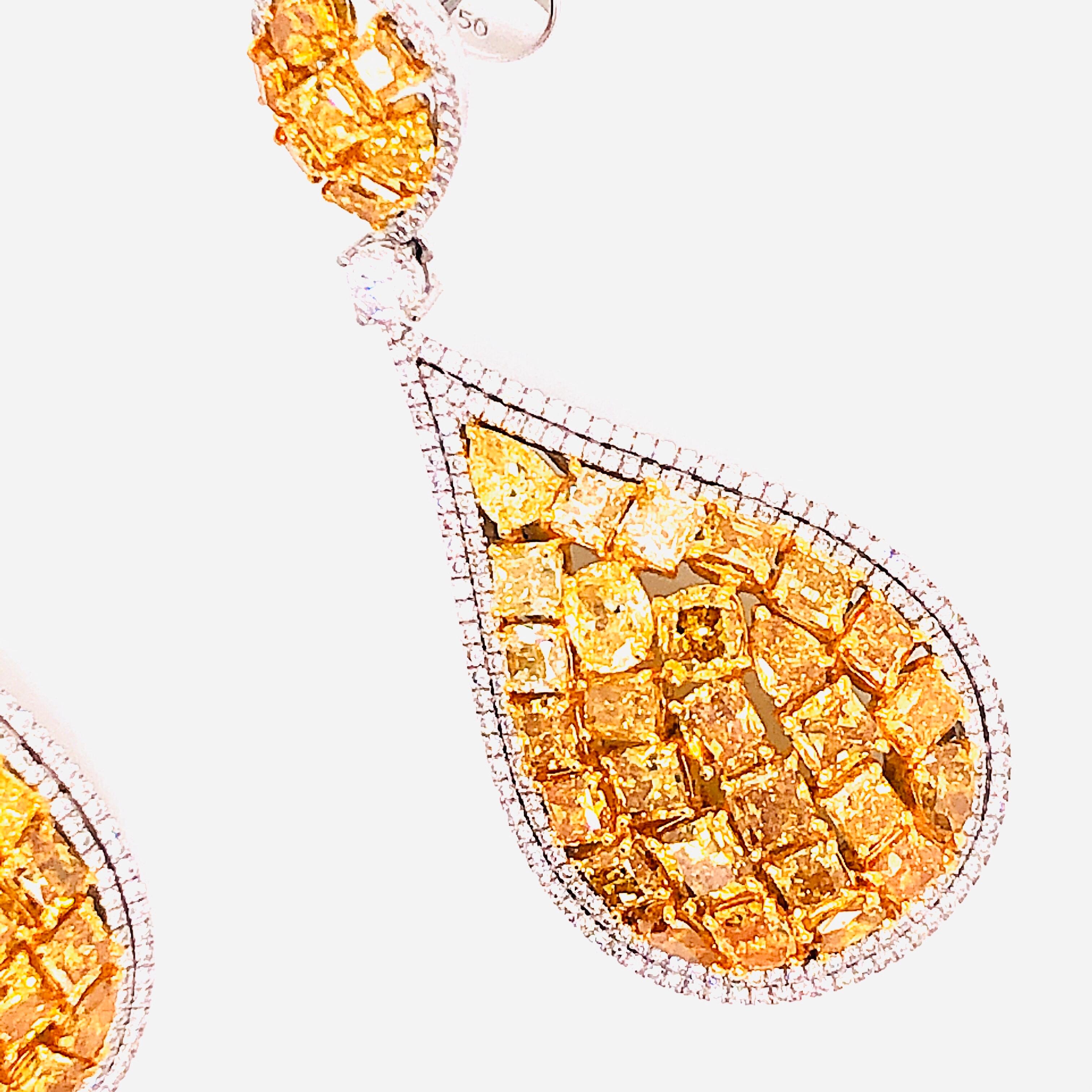 Created in the Emilio Atelier, these striking earrings consists of different shaped natural yellow diamonds. The diamonds are vvs1-vs2 in clarity overall. The total weight is approximately 12.75 carats. They have tremendous sparkle, and are a great