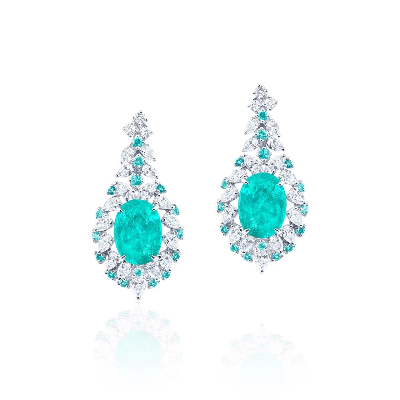 From Emilio Jewelry, a dealer/wholesaler located on New Yorks iconic fifth avenue,
two fine Paraibas totaling 9.69ct 
Matching setting: white diamonds totaling approximately 3.45 carats, Paraiba tourmalines totaling approximately 0.21