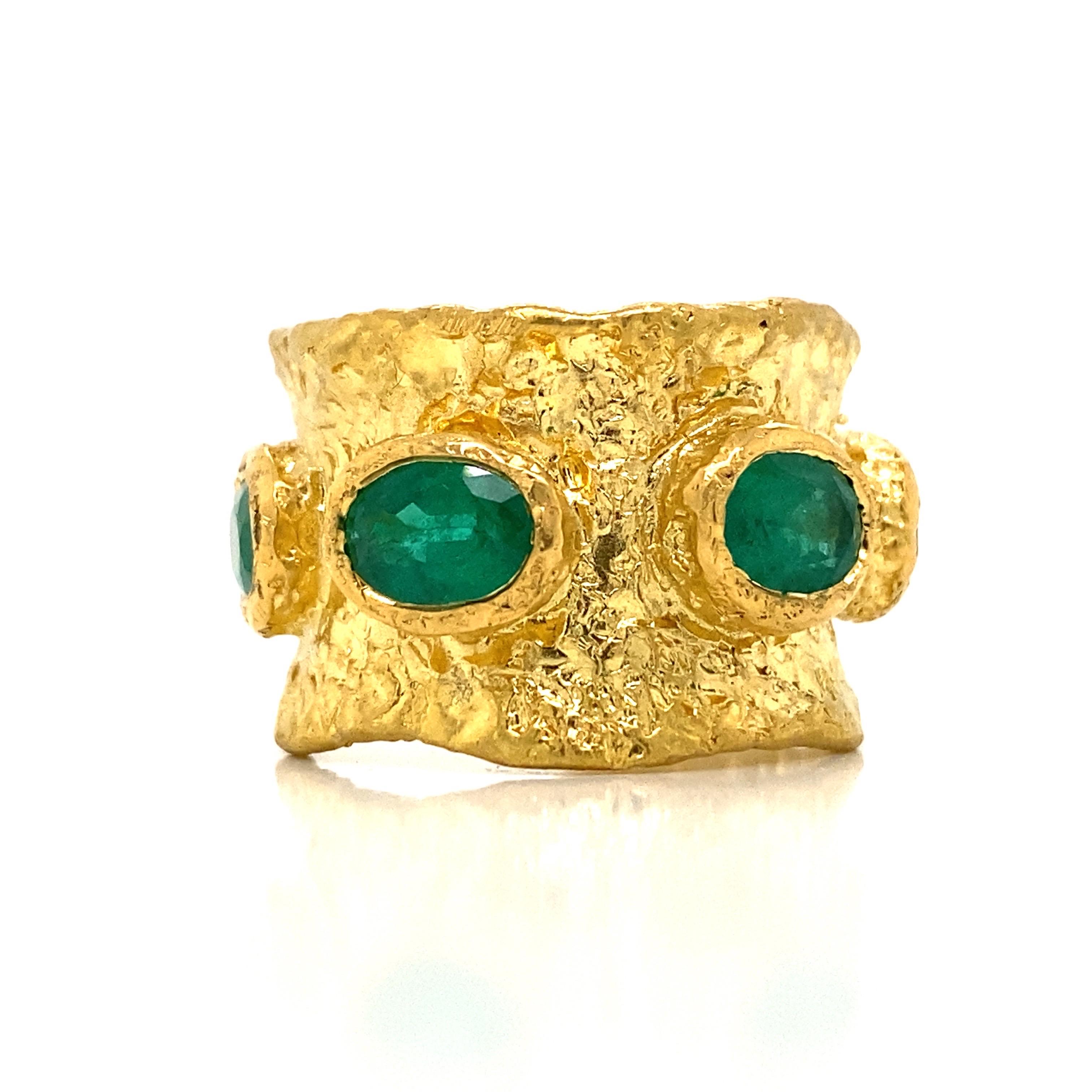From the vault at Emilio Jewelry located on New York's iconic Fifth Avenue,
Featuring 5 ancient cut multi color sapphires, totally approximately 3.50 carats of emeralds. Set in a hand made 22 Karat gold hammered ring which is bold and breathtaking!!