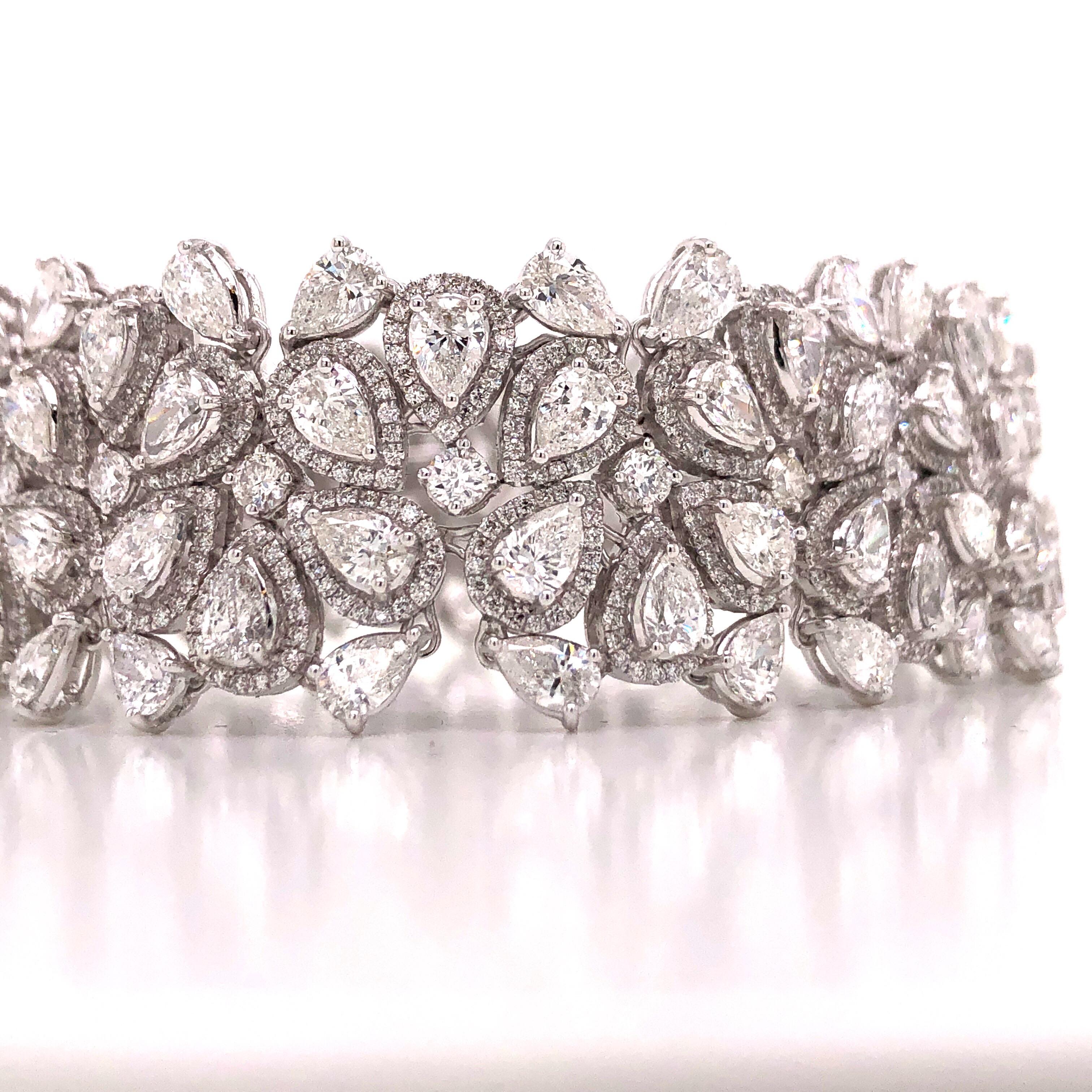 Hand made in the Emilio Atelier this bracelet is 21mm wide and 7 inches long. 265 pear shape and round diamonds totaling approx 22.20 carats of diamonds. Set in 18k white gold. 
Color: E-F 
Clarity: Vvs1-Vs2 overall 
Professional appraisal included