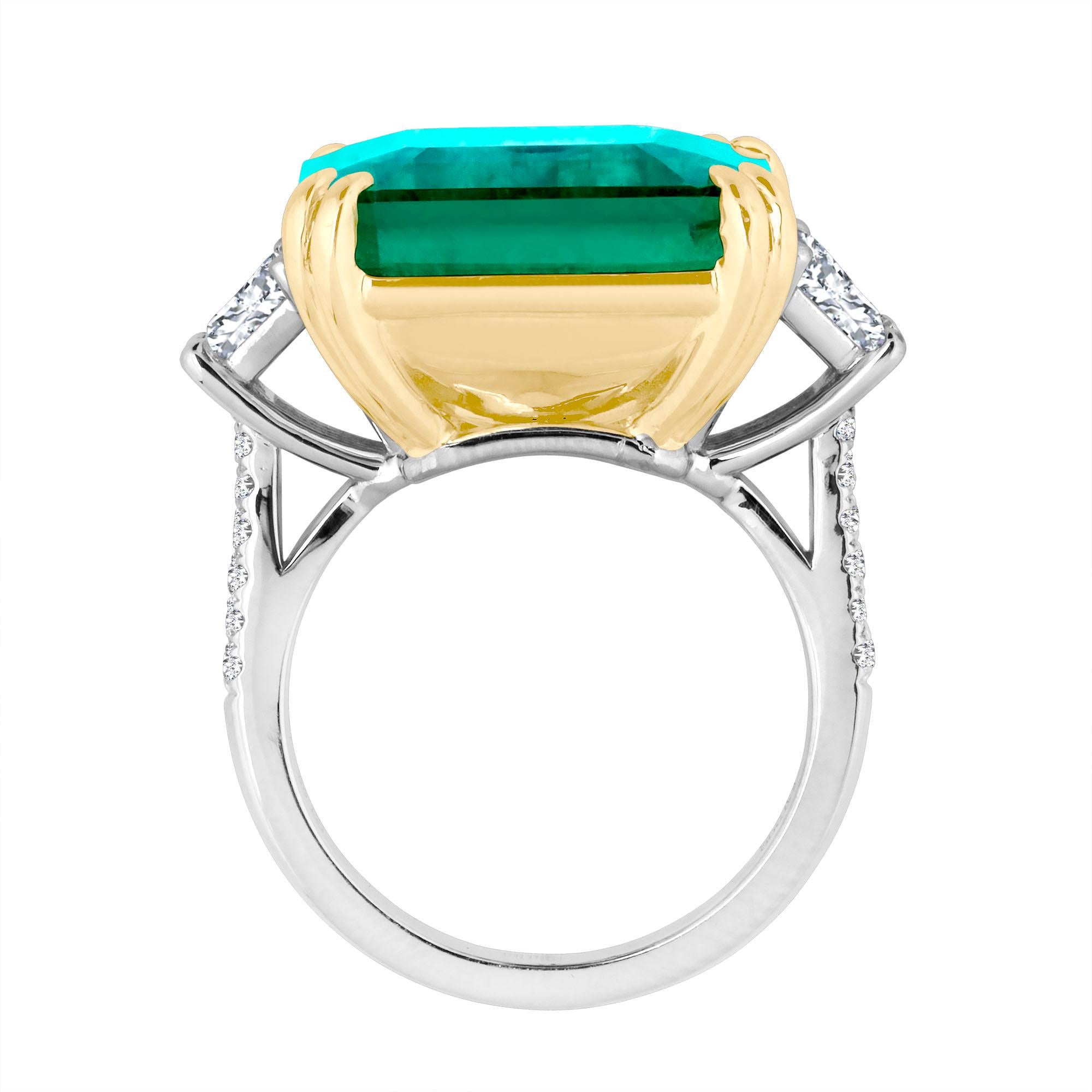Hand made in the Emilio Jewelry Factory, A gorgeous bright green Genuine Emerald Cut Certified Columbian Emerald 21.11 Carats set in the center. The emerald is extremely clean and completely eye clean. The emerald cutting is exceptional. The color