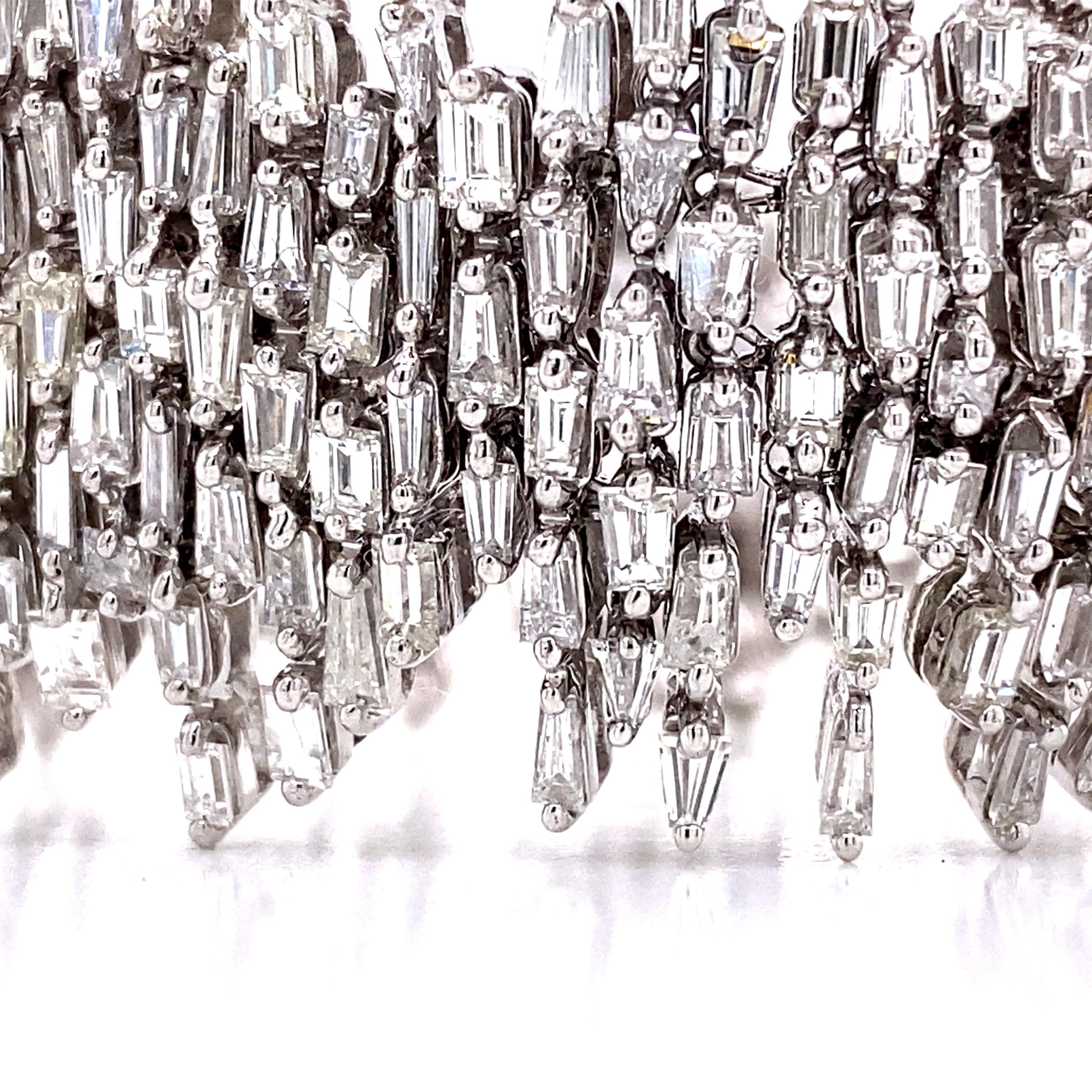 From the vault at Emilio Jewelry New York, hand made in our own atelier,

This bracelet is a true work of art. Featuring 476 tapered baguettes, each and every link was hand made to fit these irregular size diamonds. 
Color: G
clarity: vs1 
Please