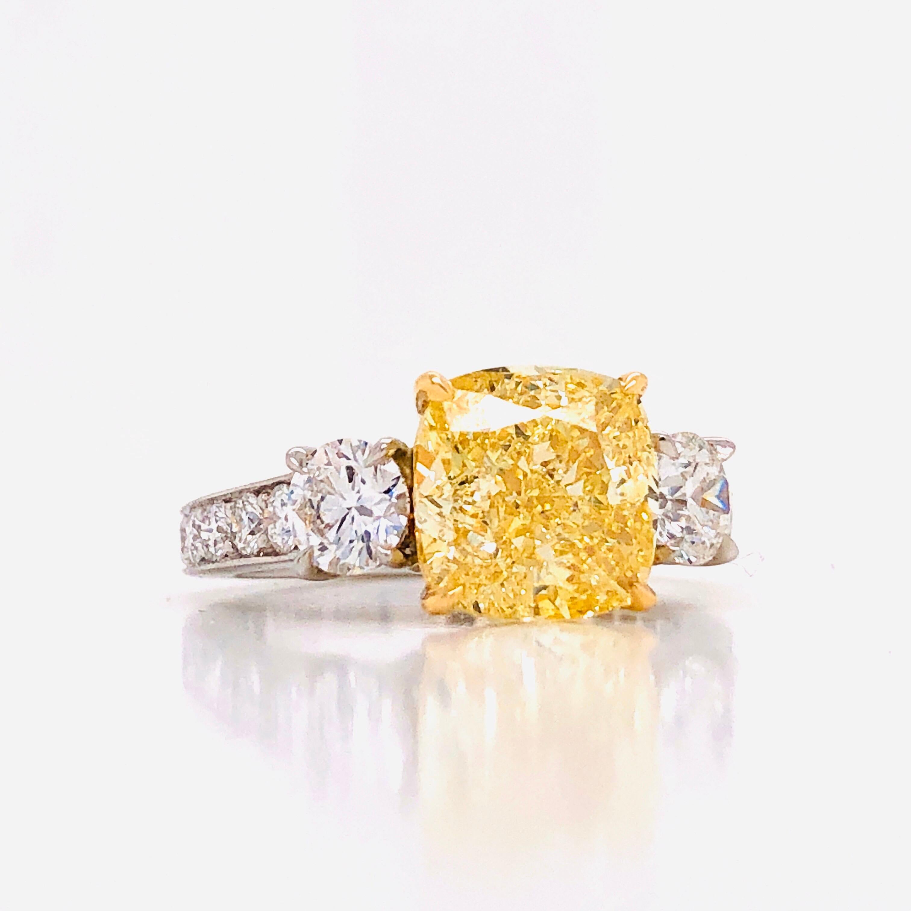 Emilio Jewelry 4.91 Carat GIA Certified Fancy Yellow Diamond Ring
This amazing ring is unique and well thought out before Emilio designed it! Most women today want a ring that is striking, yet humble enough to wear to perform everyday errands. This