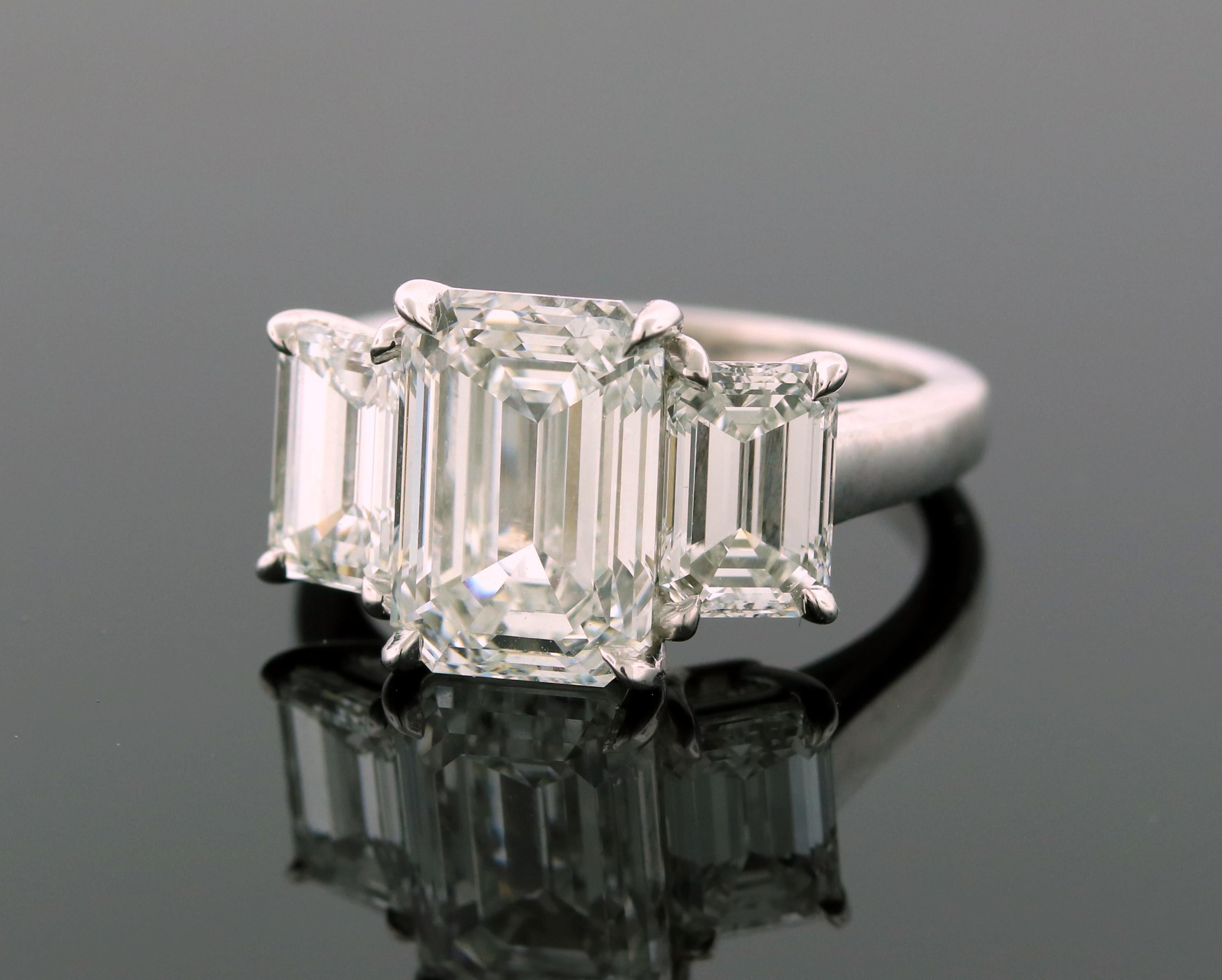 Hand made in the Emilio Jewelry factory, this ring is a superb example of the finest life has to offer! 
All 3 diamonds are GIA certified. Copies of the certificates are found in the images. 
Center Diamond: 4.13ct emerald cut E color Vs2 Clarity