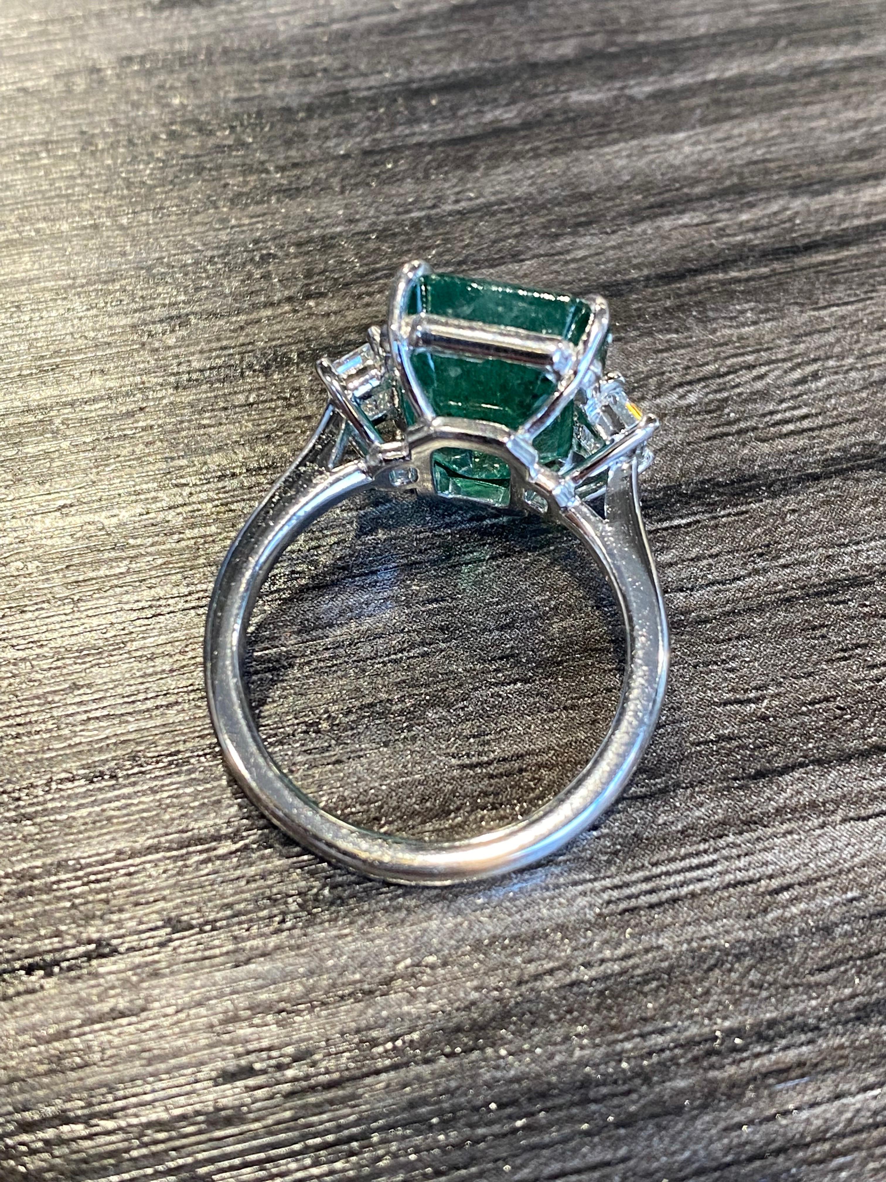 From Emilio Jewelry, a well known and respected wholesaler/dealer located in the Iconic Gem Tower/Gia Building in New York's Diamond District.
Total weight listed in title. 
Center emerald: 6.67ct emerald cut emerald 
Side diamonds: Gia certified