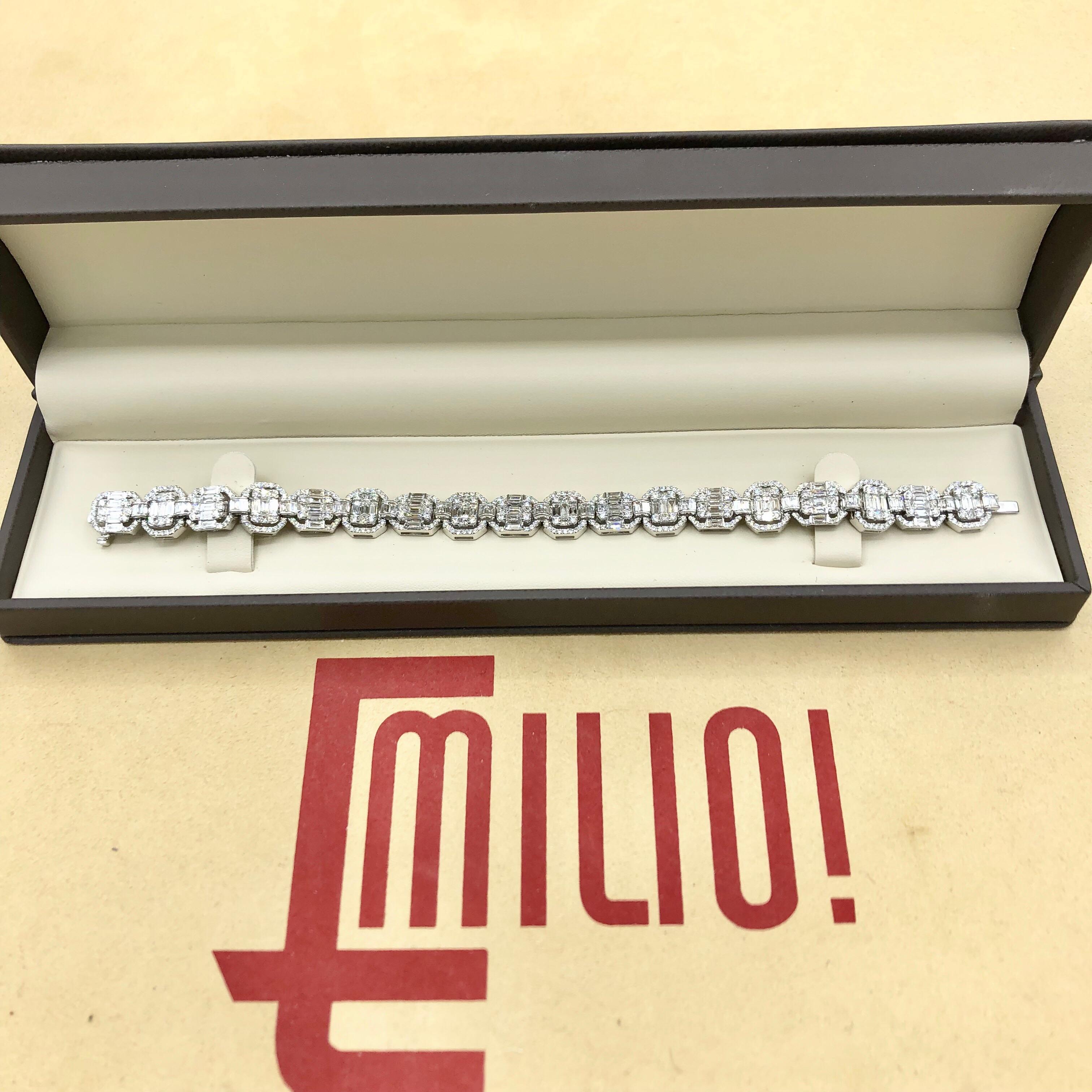 Hand made in the Emilio Jewelry Factory. Here are the details
Metal: 18k
Natural Diamonds: 9.49 carats mixed shapes including princess cut, round, and baguette diamonds to create an illusion of large single stones. 
Color/Clarity: E color Vvs1