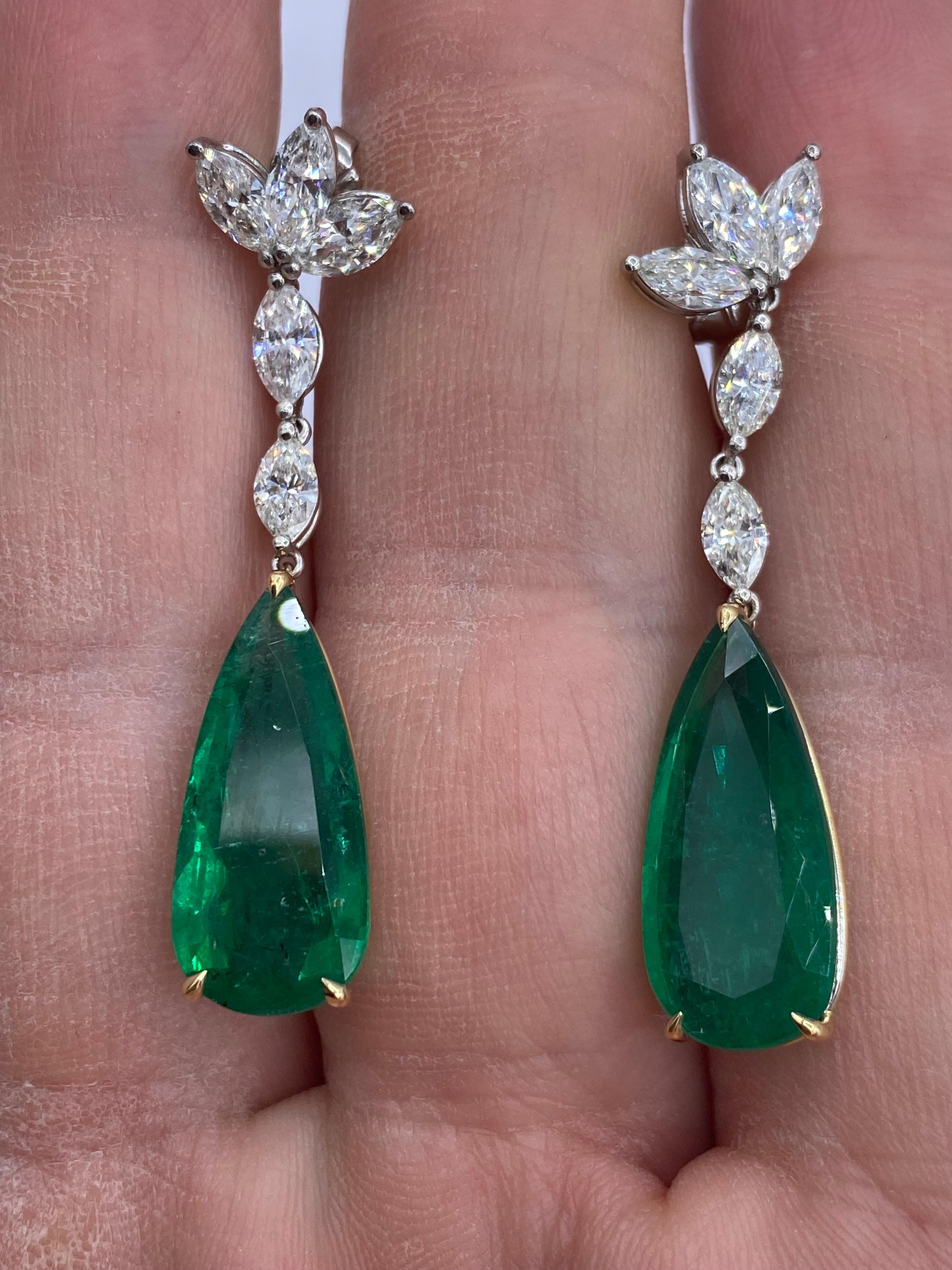 From Emilio Jewelry, a well known and respected wholesaler/dealer located on New York’s iconic Fifth Avenue, 
2 gorgeous teardrop emeralds totaling 12.98 carats, are the focal point of this earring. The emeralds are not heavy at all, and give a