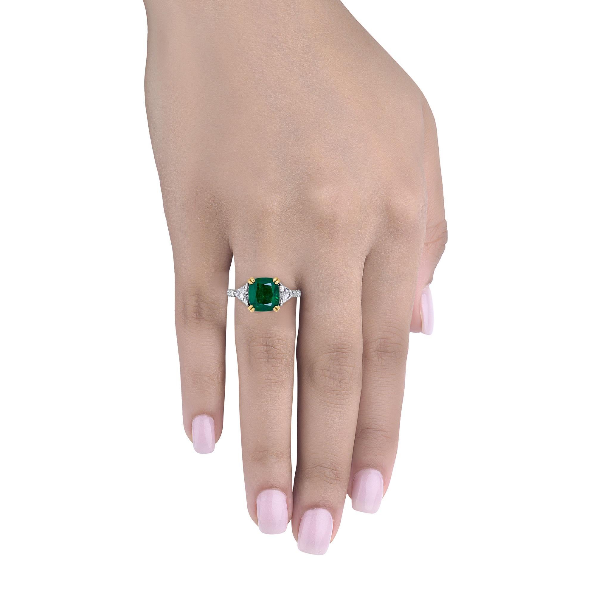 Hand made in the Emilio Jewelry Factory, A gorgeous deep green Cushion Zambian Emerald 3.55 Carats set in the center. The emerald is very clean and completely eye clean. 
Center Emerald Dimensions: 9.24x8.44 
The diamonds total ..69ct and are E-F