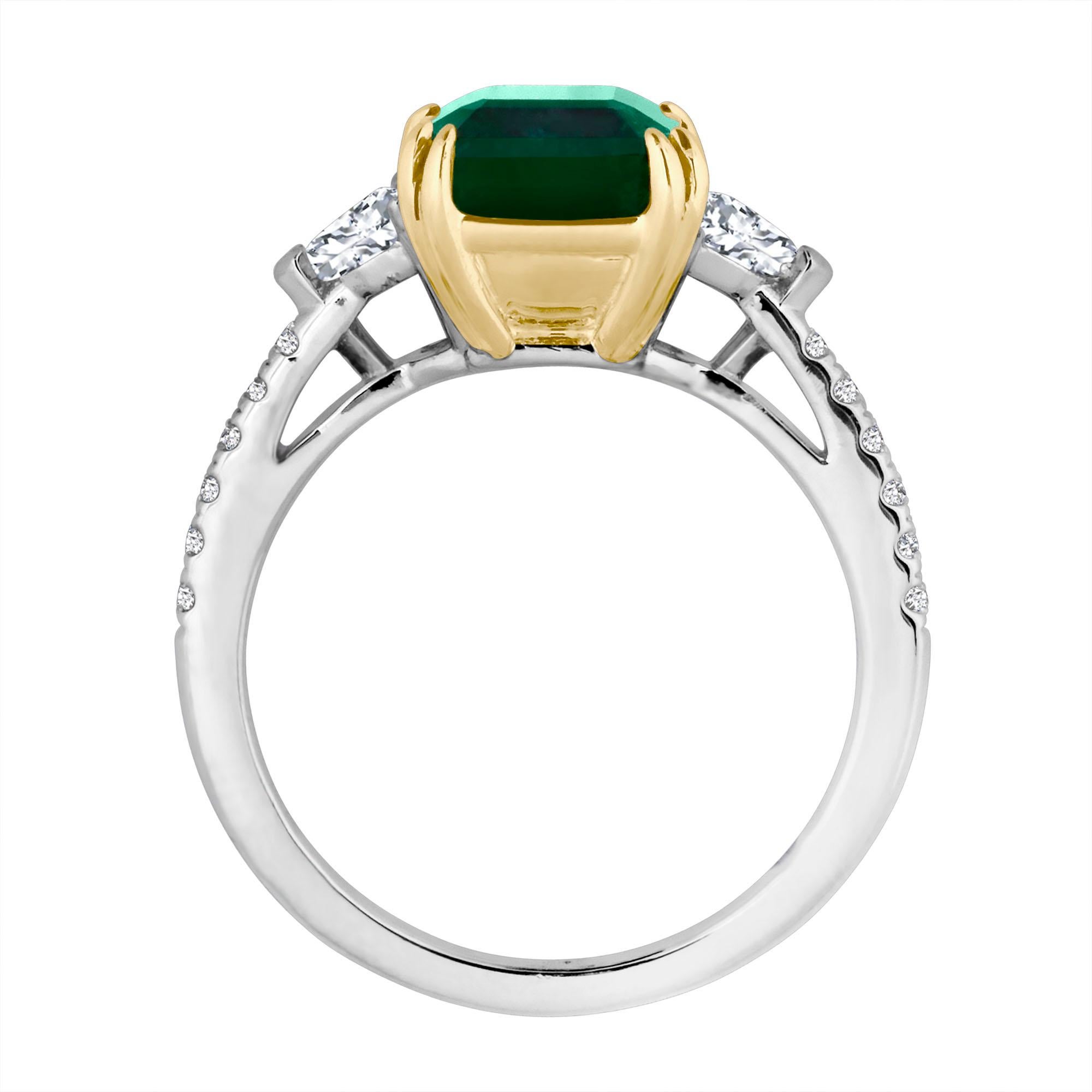Hand made in the Emilio Jewelry Factory, A gorgeous deep green Emerald Cut Zambian Emerald 3.90ct set in the center. The emerald is fairly clean and completely eye clean. What makes this ring extremely unique are the Epaulette Cut Side Diamonds