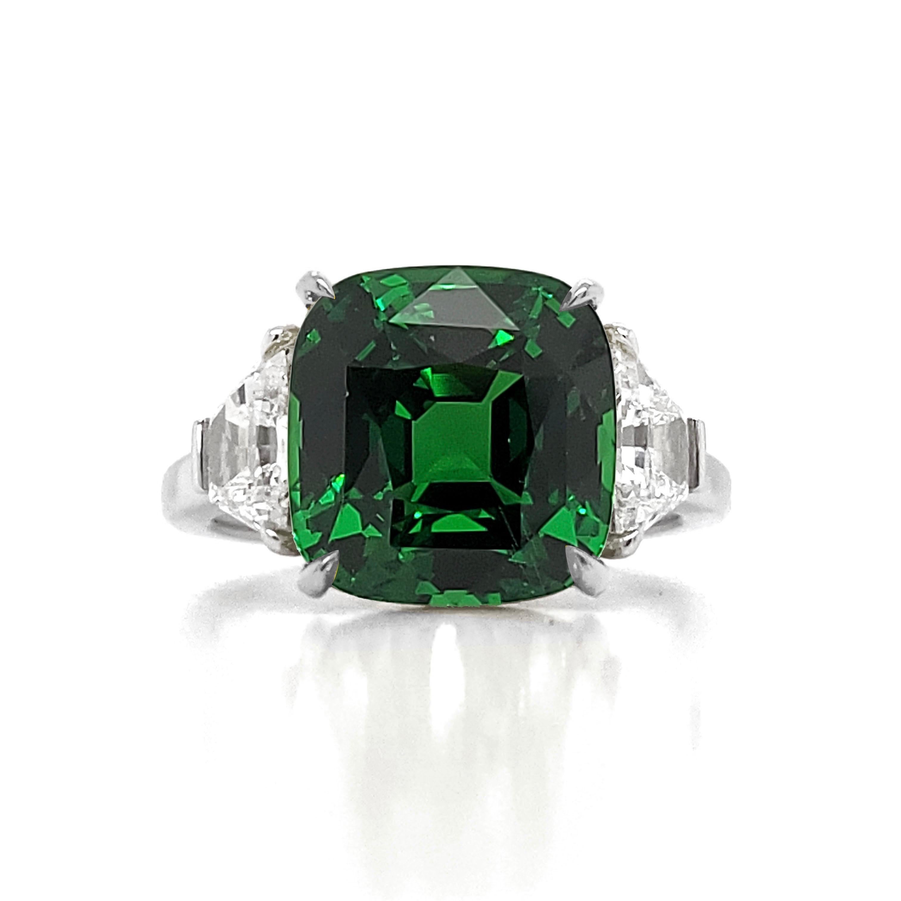 From the vault at Emilio Jewelry, Located On New York’s Iconic Fifth Avenue:
Showcasing a magnificent natural vivid green Tsavorite with no heat treatment and completely natural in the center. It has excellent transparency and very clean. Set in
